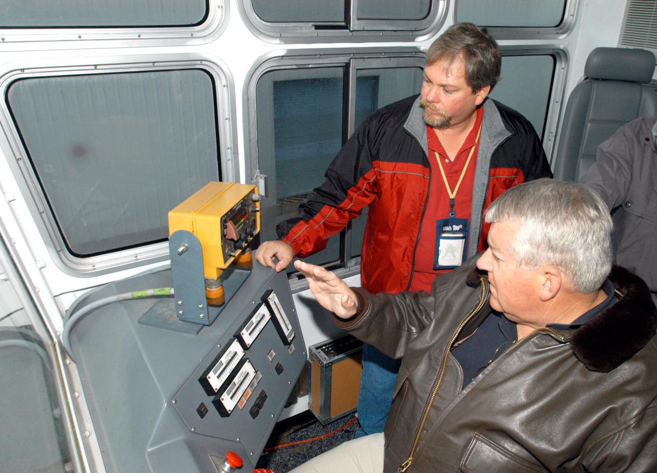 KENNEDY SPACE CENTER, FLA. - Bill Pickavance (in front), vice president, associate program manager of Florida Operations, United Space Alliance, joins workers Sam Dove, left, and Dan Drake in the cab of the Crawler Transporter before a road test. The Crawler Transporter that will move Space Shuttle Discovery to the launch pad for Return to Flight is taking its first road test following the replacement of all its shoes. The crawlers have 456 shoes, 57 per belt (8 belts in all). Each shoe weighs 2,200 pounds. Cracks appeared in the shoes in recent years, spurring a need for replacement. The new manufacturer, in Duluth, Minn., has improved the design for a safe Return to Flight and use through the balance of the Space Shuttle Program.