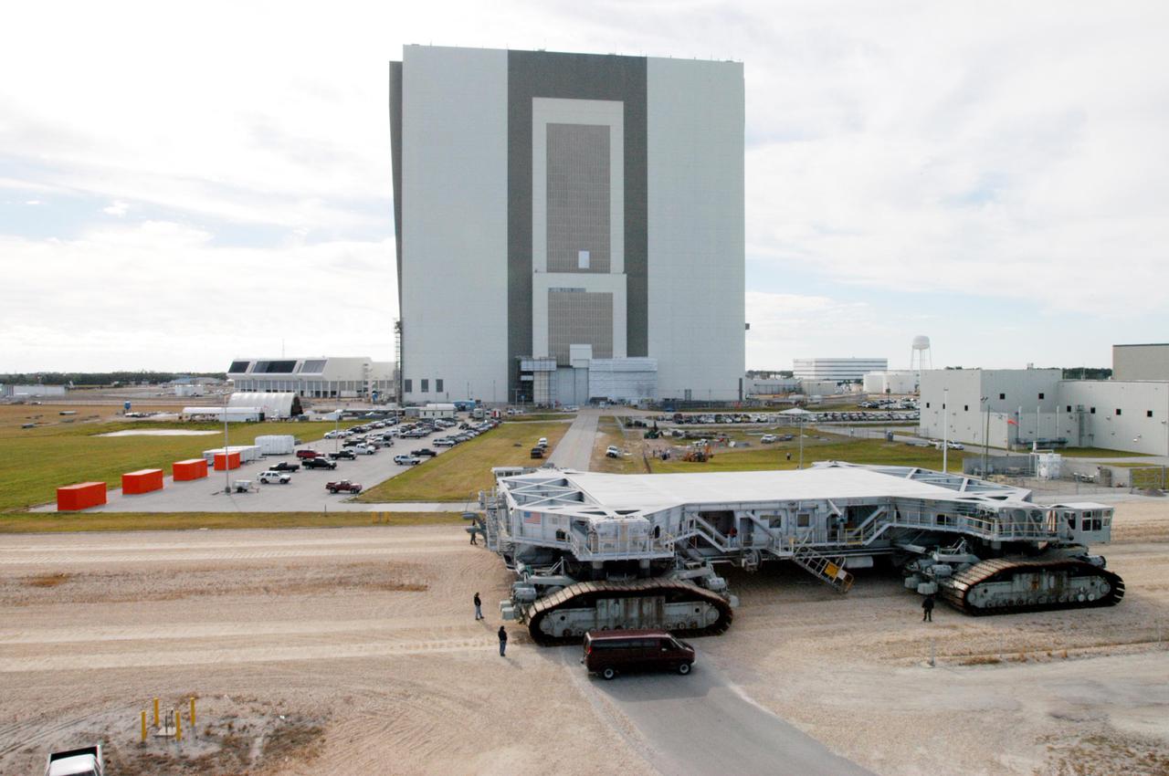 KENNEDY SPACE CENTER, FLA. - The Crawler Transporter sits behind the Vehicle Assembly Building after its road test of the new shoes. The Crawler Transporter that will move Space Shuttle Discovery to the launch pad for Return to Flight is taking its first road test following the replacement of all its shoes. The crawlers have 456 shoes, 57 per belt (8 belts in all). Each shoe weighs 2,200 pounds. Cracks appeared in the shoes in recent years, spurring a need for replacement. The new manufacturer, in Duluth, Minn., has improved the design for a safe Return to Flight and use through the balance of the Space Shuttle Program.