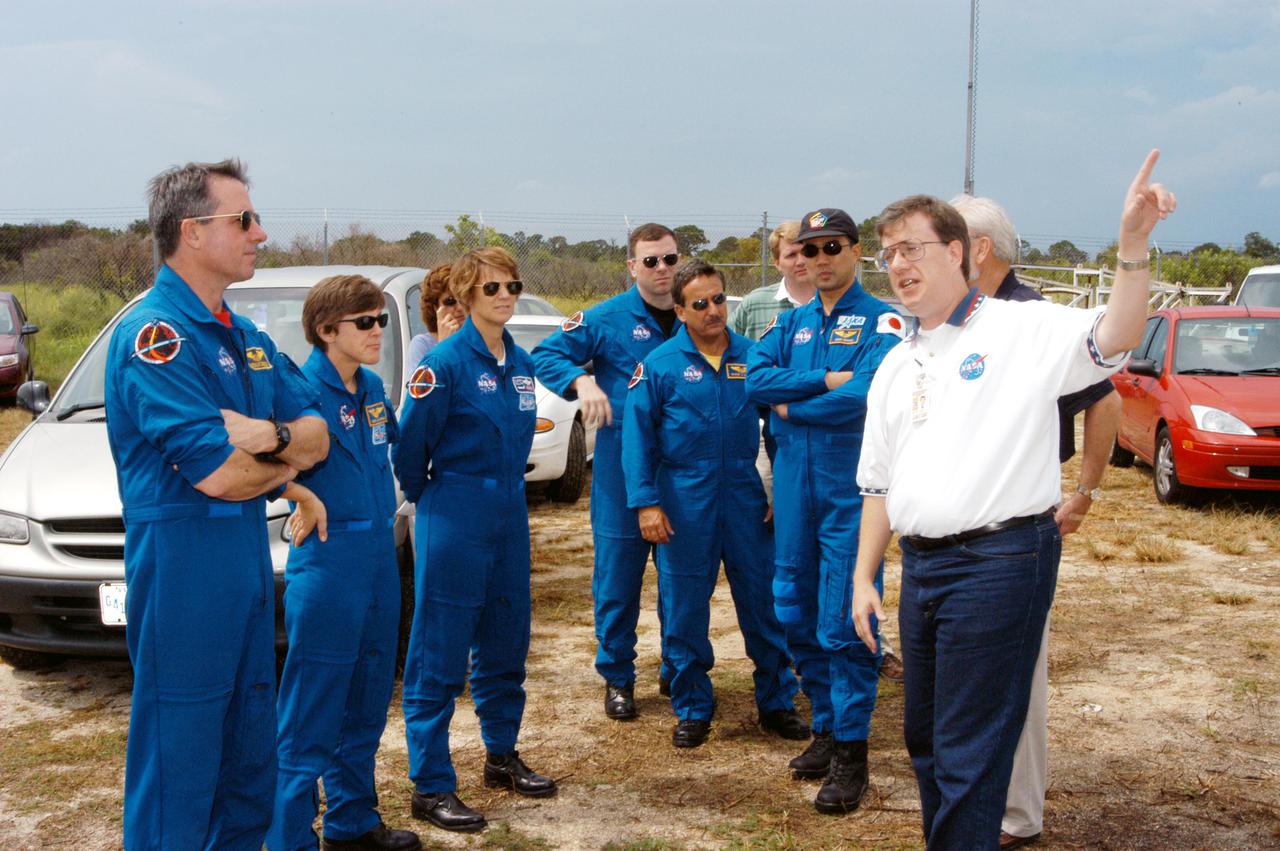 KENNEDY SPACE CENTER, FLA.  - Members of the STS-114 crew learn about a 30-foot-diameter C-band antenna and smaller X-band antenna being installed at KSC, north of the Haulover Canal, from Tony Griffith, JSC project manager for the Ascent Debris Radar Working Group.  From left are Mission Specialists Stephen Robinson and Wendy Lawrence; Commander Eileen Collins and Pilot James Kelly, and Mission Specialists Charles Camarda and Soichi Noguchi.  The antennas are being tested during the launch of a Delta II rocket carrying NASA’s MESSENGER spacecraft bound for the planet Mercury that will work together to create an image of the Delta rocket in flight. The test will evaluate the use of the radars as part of NASA’s Return to Flight program for the Space Shuttle to observe possible debris coming from the Shuttle during launch.  If successful, the radar configuration could be used on ships downrange, including on one of the solid rocket booster retrieval ships.  And it may enable the return to launching Space Shuttles at night.  The launch window for Return to Flight mission STS-114 is May 12 through June 3, 2005.