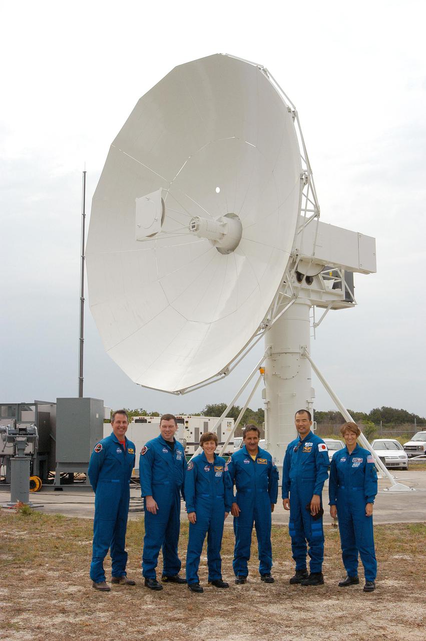 KENNEDY SPACE CENTER, FLA.  - Members of the STS-114 crew pose for a photo in front of the 30-foot-diameter C-band antenna installed north of the Haulover Canal. A smaller X-band antenna was also installed.   From left are Mission Specialist Stephen Robinson, Pilot James Kelly, Mission Specialists Wendy Lawrence, Charles Camarda and Soichi Noguchi, and Commander Eileen Collins. The antennas are being tested during the launch of a Delta II rocket carrying NASA’s MESSENGER spacecraft bound for the planet Mercury that will work together to create an image of the Delta rocket in flight. The test will evaluate the use of the radars as part of NASA’s Return to Flight program for the Space Shuttle to observe possible debris coming from the Shuttle during launch.  If successful, the radar configuration could be used on ships downrange, including on one of the solid rocket booster retrieval ships.  And it may enable the return to launching Space Shuttles at night.  The launch window for Return to Flight mission STS-114 is May 12 through June 3, 2005.