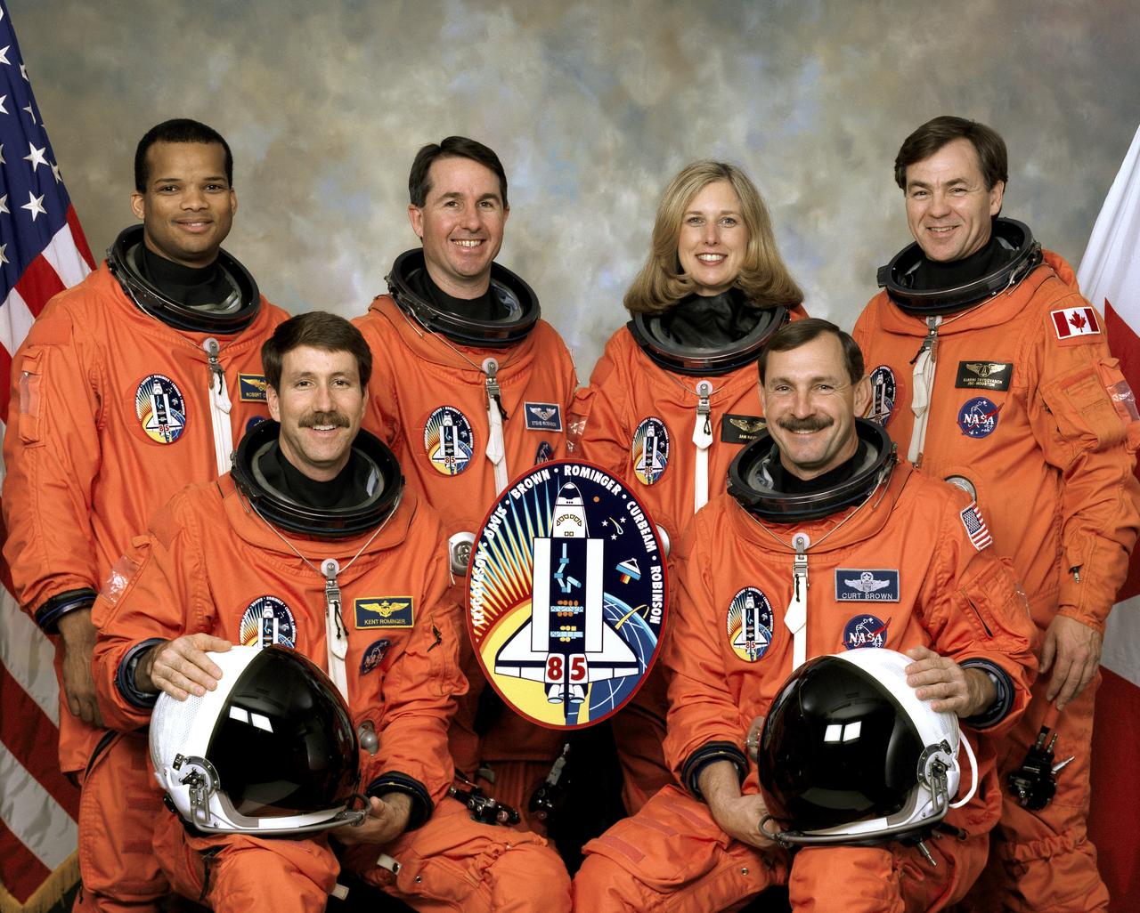 Five NASA astronauts and a Canadian payload specialist pause from their training schedule to pose for the traditional crew portrait for their mission, STS-85. In front are astronauts Curtis L. Brown, Jr. (right), mission commander, and Kent V. Rominger, pilot. On the back row, from the left, are astronauts Robert L. Curbeam, Jr., Stephen K. Robinson, and N. Jan Davis, all mission specialists, along with the Canadian Space Agency’s (CSA) payload specialist, Bjarni Tryggvason. The five launched into space aboard the Space Shuttle Discovery on August 7, 1997 at 10:41:00 a.m. (EDT). Major payloads included the satellite known as Cryogenic Infrared Spectrometers and Telescopes for the Atmosphere-Shuttle Pallet Satellite-2 CRISTA-SPAS-02. CRISTA; a Japanese Manipulator Flight Development (MFD); the Technology Applications and Science (TAS-01); and the International Extreme Ultraviolet Hitchhiker (IEH-02).