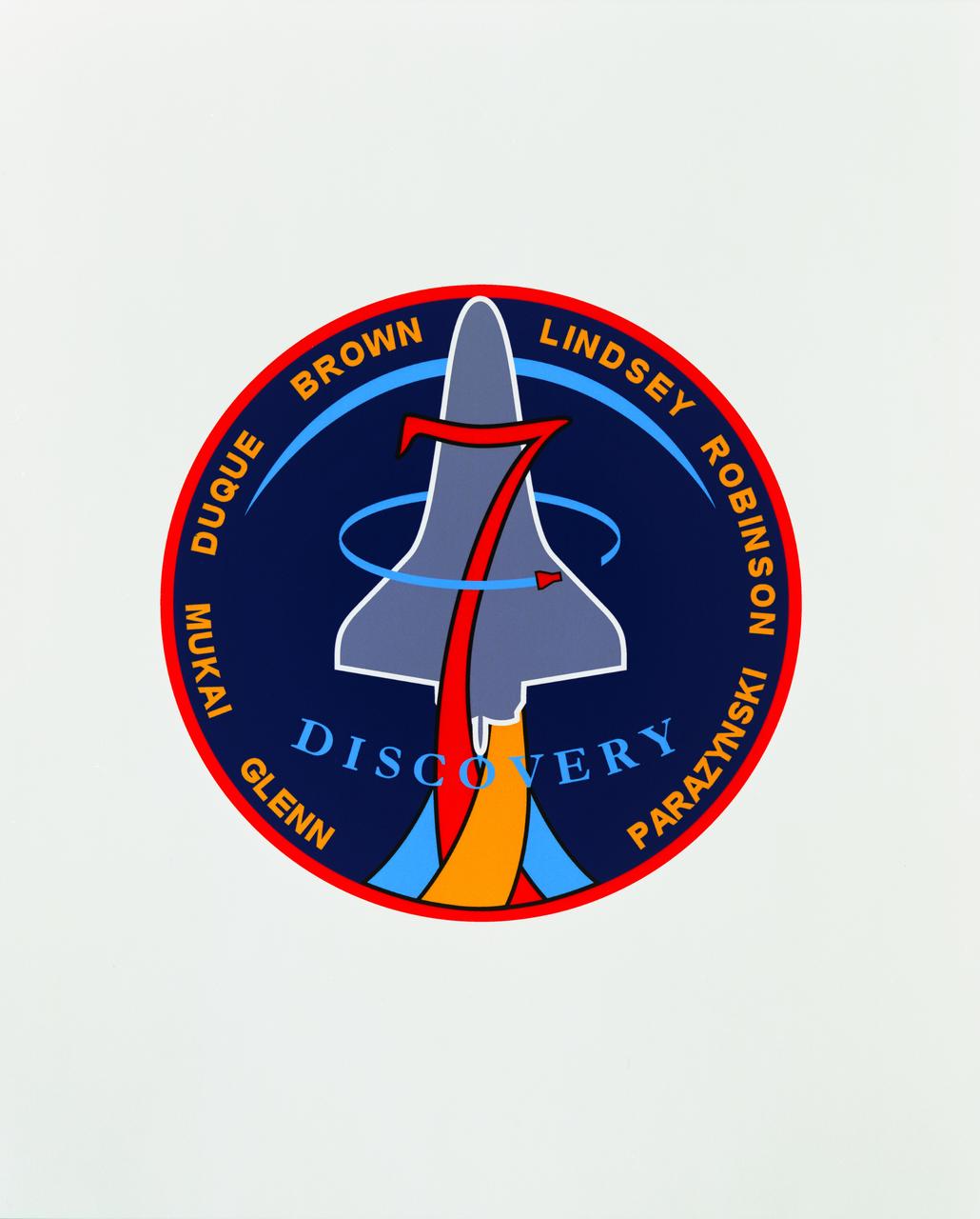 The STS-95 patch, designed by the crew, is intended to reflect the scientific, engineering, and historic elements of the mission. The Space Shuttle Discovery is shown rising over the sunlit Earth limb, representing the global benefits of the mission science and the solar science objectives of the Spartan Satellite. The bold number '7' signifies the seven members of Discovery's crew and also represents a historical link to the original seven Mercury astronauts. The STS-95 crew member John Glenn's first orbital flight is represented by the Friendship 7 capsule. The rocket plumes symbolize the three major fields of science represented by the mission payloads: microgravity material science, medical research for humans on Earth and in space, and astronomy. 