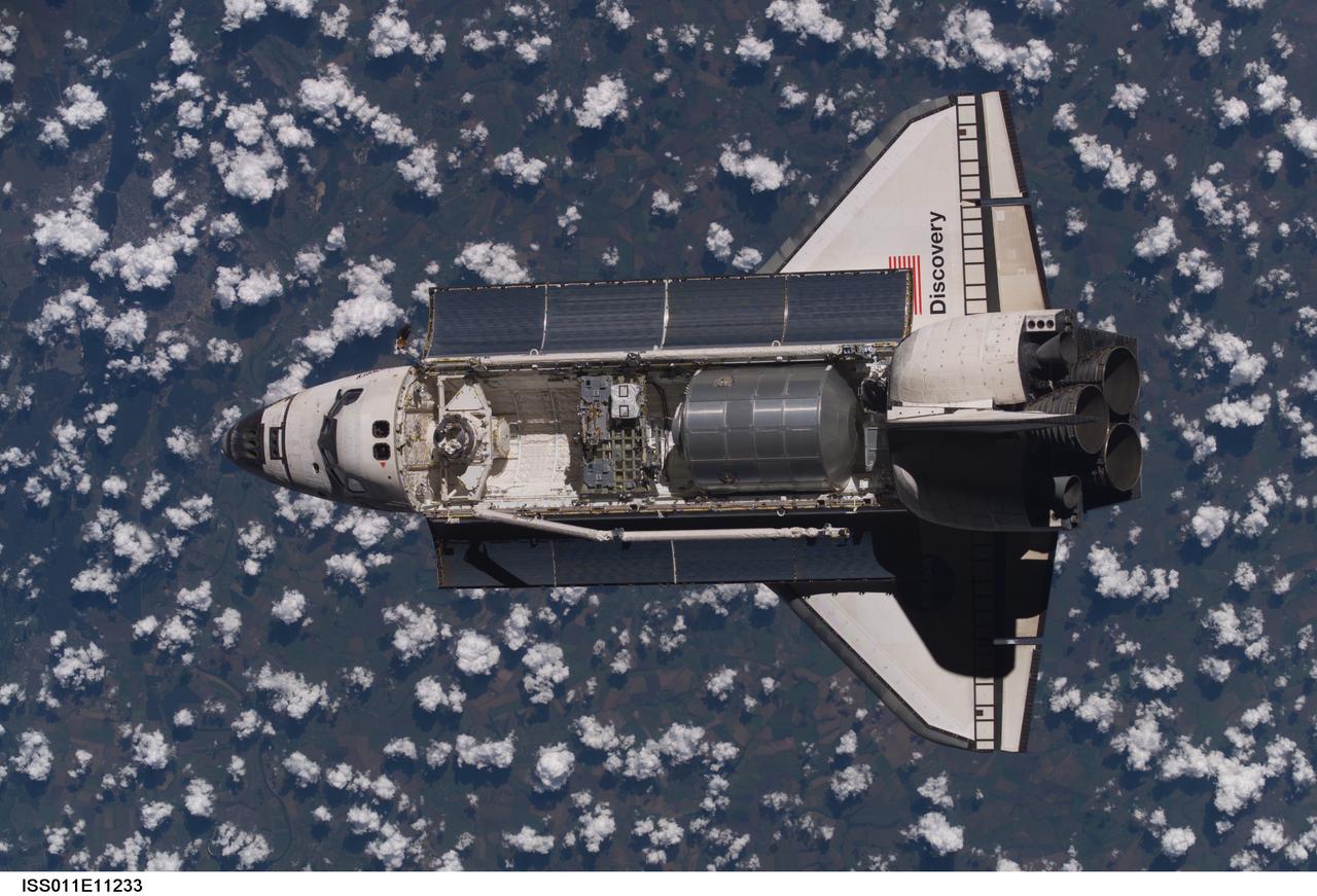 Launched on July 26, 2005 from the Kennedy Space Center in Florida, STS-114 was classified as Logistics Flight 1. Among the Station-related activities of the mission were the delivery of new supplies and the replacement of one of the orbital outpost's Control Moment Gyroscopes (CMGs). STS-114 also carried the Raffaello Multi-Purpose Logistics Module (MPLM) and the External Stowage Platform-2. Back dropped by popcorn-like clouds, the MPLM can be seen in the cargo bay as Discovery undergoes rendezvous and docking operations. Cosmonaut Sergei K. Kriklev, Expedition 11 Commander, and John L. Phillips, NASA Space Station officer and flight engineer photographed the spacecraft from the International Space Station (ISS).