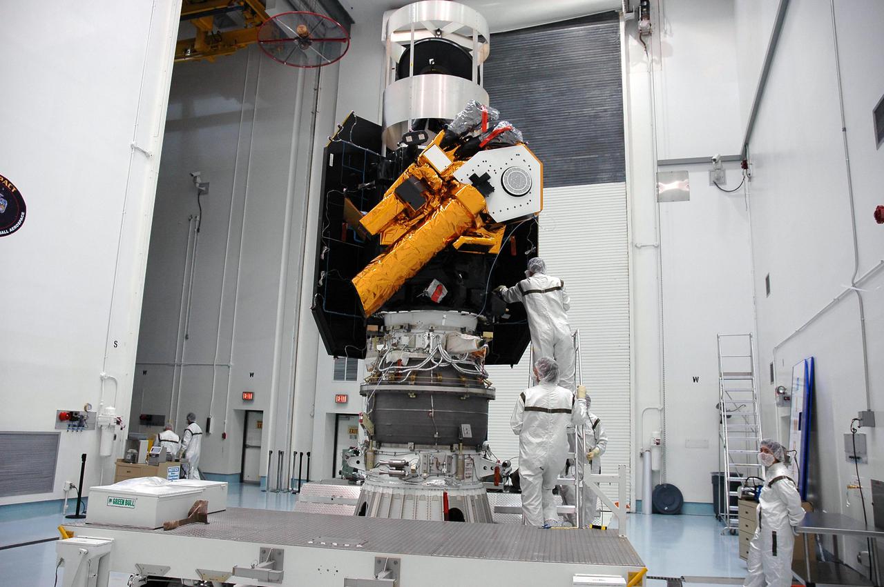KENNEDY SPACE CENTER, FLA. - The Deep Impact spacecraft waits at Astrotech Space Operations in Titusville, Fla., for placement of a protective cover before the canister is installed around it. Once the spacecraft is completely covered, it will be transferred to Launch Pad 17-B on Cape Canaveral Air Force Station, Fla.  Then, in the mobile service tower, the fairing will be installed around the spacecraft.  The fairing is a molded structure that fits flush with the outside surface of the Delta II upper stage booster and forms an aerodynamically smooth joint, protecting the spacecraft during launch.  Scheduled for liftoff Jan. 12,  Deep Impact will probe beneath the surface of Comet Tempel 1 on July 4, 2005, when the comet is 83 million miles from Earth.  After releasing a 3- by 3-foot projectile to crash onto the surface, Deep Impact’s flyby spacecraft will reveal the secrets of its interior by collecting pictures and data of how the crater forms, measuring the crater’s depth and diameter as well as the composition of the interior of the crater and any material thrown out, and determining the changes in natural outgassing produced by the impact.  It will send the data back to Earth through the antennas of the Deep Space Network.  Deep Impact is a NASA Discovery mission.
