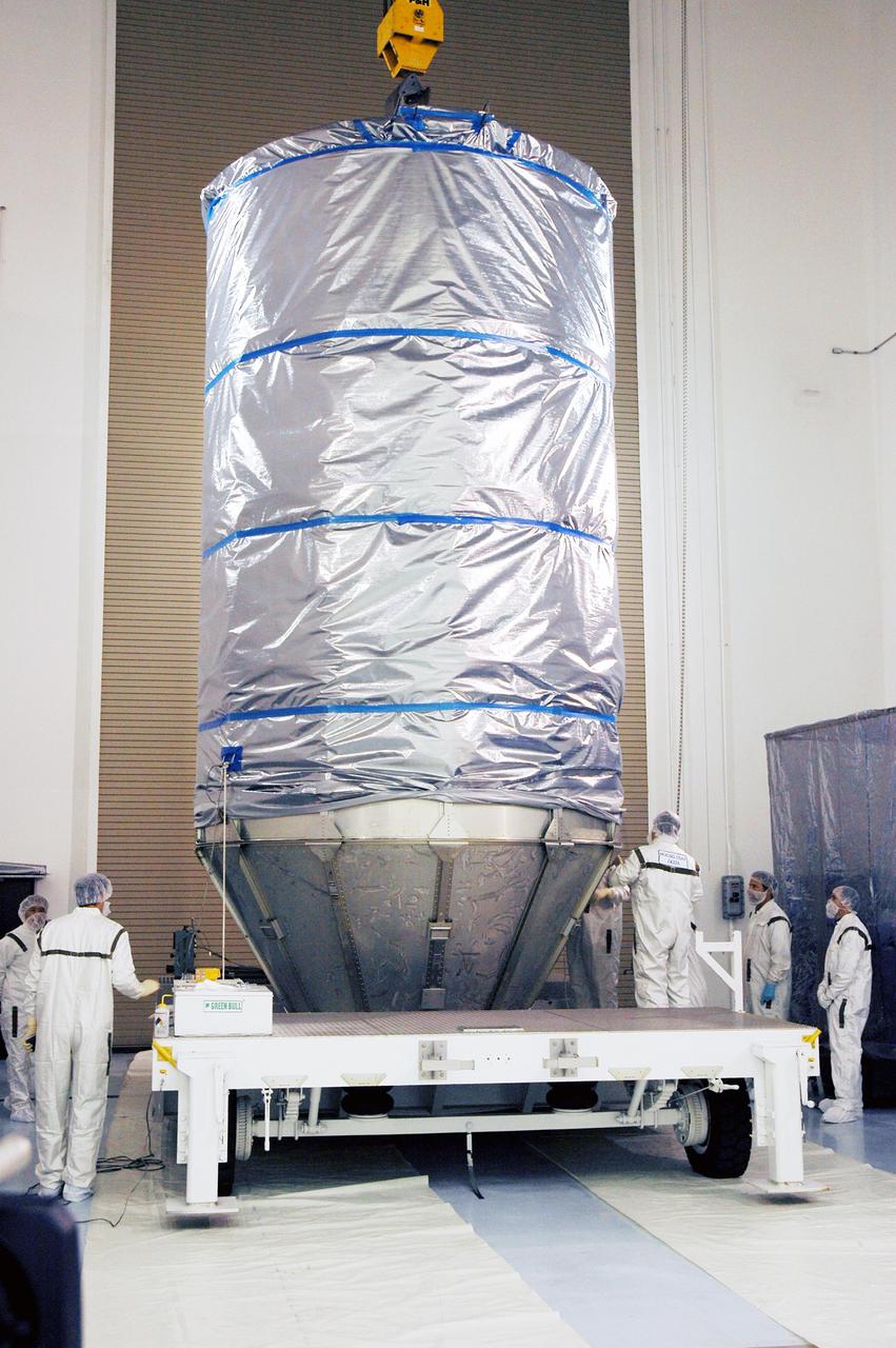KENNEDY SPACE CENTER, FLA. - At Astrotech Space Operations in Titusville, Fla., the Deep Impact spacecraft is secure in the canister for its move to Launch Pad 17-B on Cape Canaveral Air Force Station, Fla.   Then, in the mobile service tower, the fairing will be installed around the spacecraft.  The fairing is a molded structure that fits flush with the outside surface of the Delta II upper stage booster and forms an aerodynamically smooth joint, protecting the spacecraft during launch.  Scheduled for liftoff Jan. 12,  Deep Impact will probe beneath the surface of Comet Tempel 1 on July 4, 2005, when the comet is 83 million miles from Earth.  After releasing a 3- by 3-foot projectile to crash onto the surface, Deep Impact’s flyby spacecraft will reveal the secrets of its interior by collecting pictures and data of how the crater forms, measuring the crater’s depth and diameter as well as the composition of the interior of the crater and any material thrown out, and determining the changes in natural outgassing produced by the impact.  It will send the data back to Earth through the antennas of the Deep Space Network.  Deep Impact is a NASA Discovery mission.