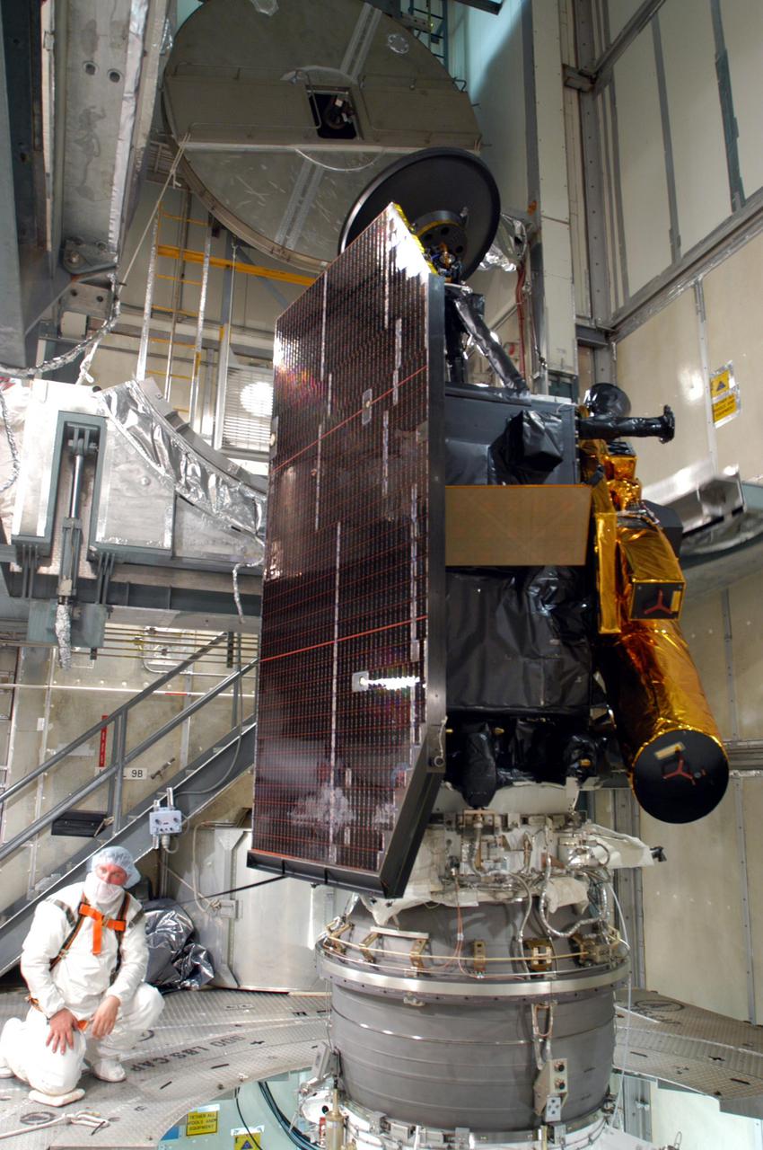 KENNEDY SPACE CENTER, FLA. - The Deep Impact spacecraft waits inside the mobile service tower on Launch Pad 17-B, Cape Canaveral Air force Station, Fla., for fairing installation. The fairing is a molded structure that fits flush with the outside surface of the Delta II upper stage booster and forms an aerodynamically smooth nosecone, protecting the spacecraft during launch and ascent. Scheduled for liftoff Jan. 12, Deep Impact will probe beneath the surface of Comet Tempel 1 on July 4, 2005, when the comet is 83 million miles from Earth. After releasing a 3- by 3-foot projectile to crash onto the surface, Deep Impact’s flyby spacecraft will reveal the secrets of its interior by collecting pictures and data of how the crater forms, measuring the crater’s depth and diameter as well as the composition of the interior of the crater and any material thrown out, and determining the changes in natural outgassing produced by the impact. It will send the data back to Earth through the antennas of the Deep Space Network. Deep Impact is a NASA Discovery mission.
