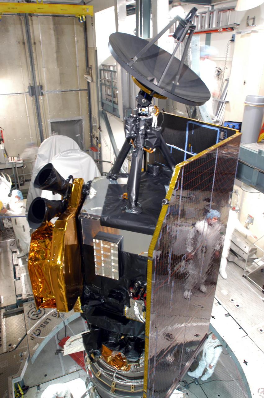 KENNEDY SPACE CENTER, FLA. - The Deep Impact spacecraft waits inside the mobile service tower on Launch Pad 17-B, Cape Canaveral Air force Station, Fla., for fairing installation. The fairing is a molded structure that fits flush with the outside surface of the Delta II upper stage booster and forms an aerodynamically smooth nosecone, protecting the spacecraft during launch and ascent.   Scheduled for liftoff Jan. 12,  Deep Impact will probe beneath the surface of Comet Tempel 1 on July 4, 2005, when the comet is 83 million miles from Earth.  After releasing a 3- by 3-foot projectile to crash onto the surface, Deep Impact’s flyby spacecraft will reveal the secrets of its interior by collecting pictures and data of how the crater forms, measuring the crater’s depth and diameter as well as the composition of the interior of the crater and any material thrown out, and determining the changes in natural outgassing produced by the impact.  It will send the data back to Earth through the antennas of the Deep Space Network.  Deep Impact is a NASA Discovery mission.