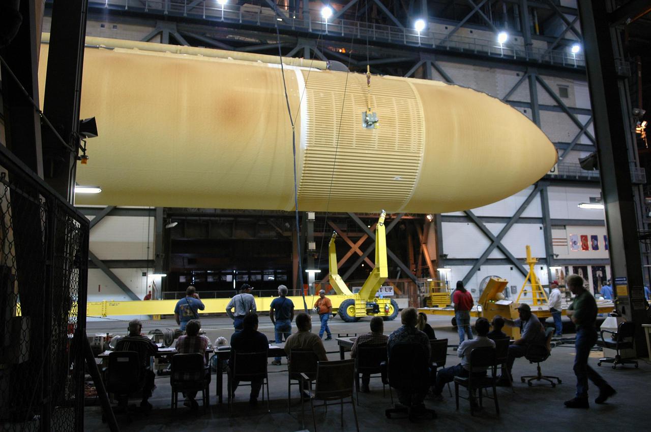 KENNEDY SPACE CENTER, FLA. - The redesigned External Tank is being raised off its transporter.   It will be lifted to a vertical position and into the 'checkout cell' of the Vehicle Assembly Building where the tank’s mechanical, electrical and thermal protection systems are inspected.  The tank will also undergo new processes resulting from its redesign, including inspection of the bipod heater and External Tank separation camera. The tank will be prepared for 'mating' to the Shuttle’s Solid Rocket Boosters. When preparations are complete, the tank will be lifted from the checkout cell, moved across the transfer aisle and into High Bay 1. It will be lowered and attached to the boosters, which are sitting on the Mobile Launch Platform.  The SRBs and ET will be flying with Shuttle Discovery for the Return to Flight mission STS-114.  The launch planning window is May 12 to June 3, 2005.