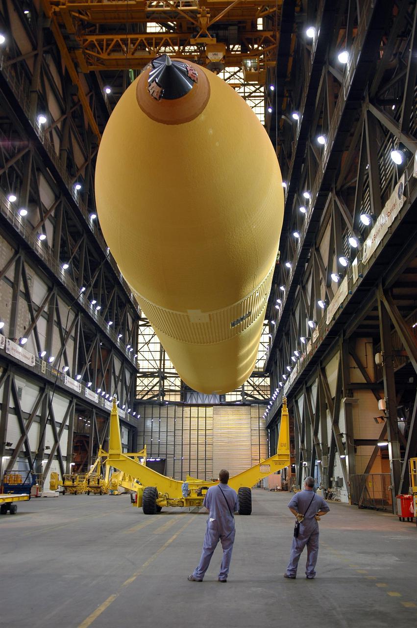 KENNEDY SPACE CENTER, FLA. - The redesigned External Tank is being raised off its transporter.  It will be lifted to a vertical position and into the 'checkout cell' of the Vehicle Assembly Building where the tank’s mechanical, electrical and thermal protection systems are inspected.   The tank will also undergo new processes resulting from its redesign, including inspection of the bipod heater and External Tank separation camera. The tank will be prepared for 'mating' to the Shuttle’s Solid Rocket Boosters. When preparations are complete, the tank will be lifted from the checkout cell, moved across the transfer aisle and into High Bay 1. It will be lowered and attached to the boosters, which are sitting on the Mobile Launch Platform.  The SRBs and ET will be flying with Shuttle Discovery for the Return to Flight mission STS-114.  The launch planning window is May 12 to June 3, 2005.