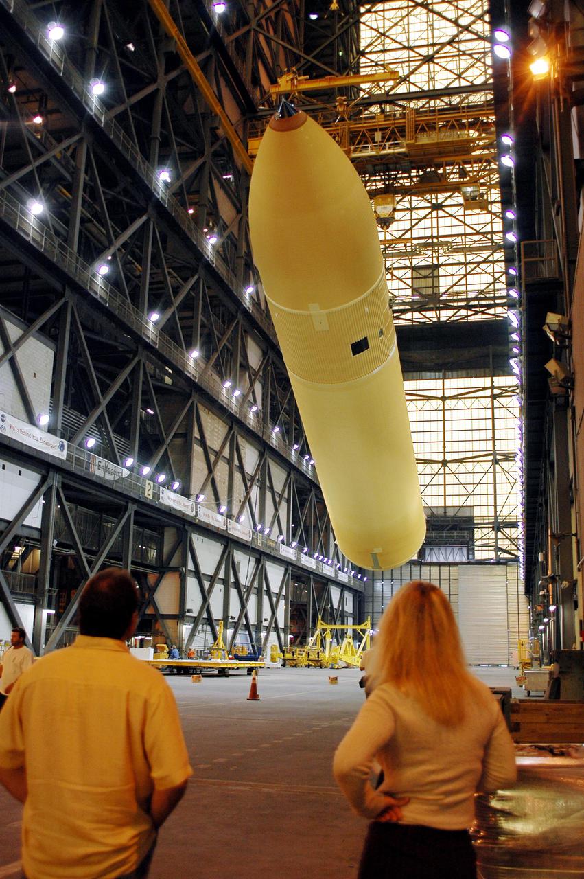 KENNEDY SPACE CENTER, FLA. - The redesigned External Tank is being raised to a vertical position in the Vehicle Assembly Building and will be lifted into the 'checkout cell' where the tank's mechanical, electrical and thermal protection systems are inspected.   The tank will also undergo new processes resulting from its redesign, including inspection of the bipod heater and External Tank separation camera. The tank will be prepared for 'mating' to the Shuttle’s Solid Rocket Boosters. When preparations are complete, the tank will be lifted from the checkout cell, moved across the transfer aisle and into High Bay 1. It will be lowered and attached to the boosters, which are sitting on the Mobile Launch Platform.  The SRBs and ET will be flying with Shuttle Discovery for the Return to Flight mission STS-114.  The launch planning window is May 12 to June 3, 2005.