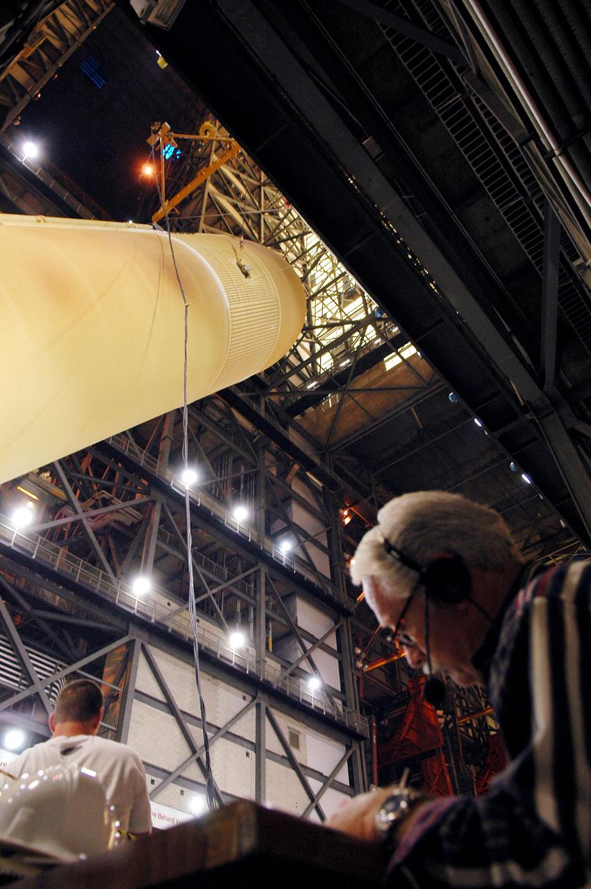 KENNEDY SPACE CENTER, FLA. - The redesigned External Tank is being raised to a vertical position in the Vehicle Assembly Building and will be lifted into the 'checkout cell' where the tank’s mechanical, electrical and thermal protection systems are inspected.  The tank will also undergo new processes resulting from its redesign, including inspection of the bipod heater and External Tank separation camera. The tank will be prepared for 'mating' to the Shuttle’s Solid Rocket Boosters. When preparations are complete, the tank will be lifted from the checkout cell, moved across the transfer aisle and into High Bay 1. It will be lowered and attached to the boosters, which are sitting on the Mobile Launch Platform.  The SRBs and ET will be flying with Shuttle Discovery for the Return to Flight mission STS-114.  The launch planning window is May 12 to June 3, 2005.