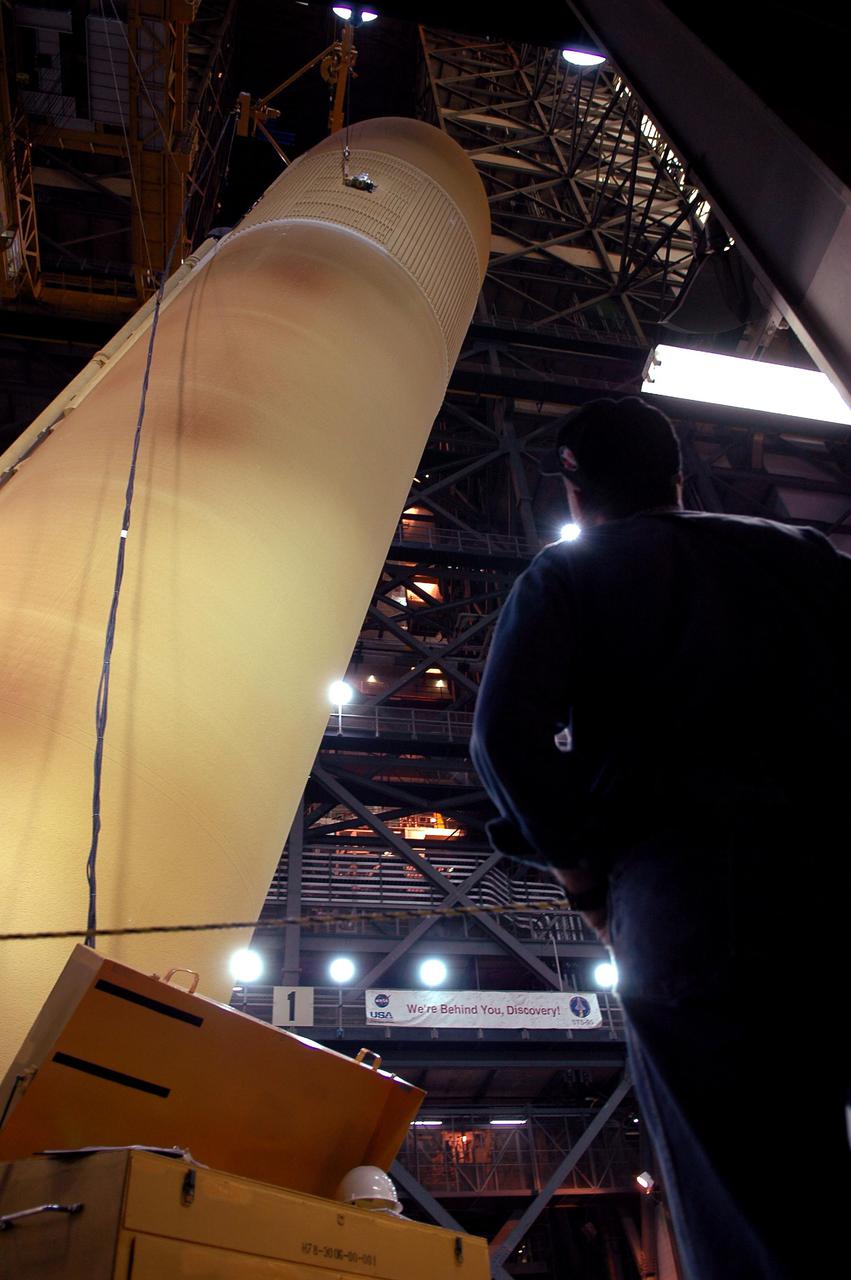 KENNEDY SPACE CENTER, FLA. - Nearly vertical, the redesigned External Tank will be lifted into the 'checkout cell' of the Vehicle Assembly Building where the tank’s mechanical, electrical and thermal protection systems are inspected.  The tank will also undergo new processes resulting from its redesign, including inspection of the bipod heater and External Tank separation camera. The tank will be prepared for 'mating' to the Shuttle’s Solid Rocket Boosters. When preparations are complete, the tank will be lifted from the checkout cell, moved across the transfer aisle and into High Bay 1. It will be lowered and attached to the boosters, which are sitting on the Mobile Launch Platform.  The SRBs and ET will be flying with Shuttle Discovery for the Return to Flight mission STS-114.  The launch planning window is May 12 to June 3, 2005.