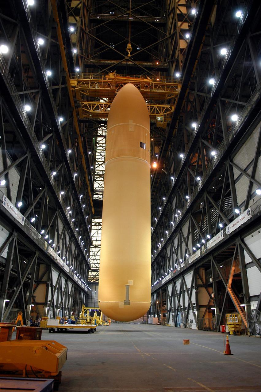 KENNEDY SPACE CENTER, FLA. - Raised to a vertical position in the Vehicle Assembly Building, the redesigned External Tank will be lifted into the 'checkout cell' where the tank’s mechanical, electrical and thermal protection systems are inspected.  The tank will also undergo new processes resulting from its redesign, including inspection of the bipod heater and External Tank separation camera. The tank will be prepared for 'mating' to the Shuttle’s Solid Rocket Boosters. When preparations are complete, the tank will be lifted from the checkout cell, moved across the transfer aisle and into High Bay 1. It will be lowered and attached to the boosters, which are sitting on the Mobile Launch Platform.  The SRBs and ET will be flying with Shuttle Discovery for the Return to Flight mission STS-114.  The launch planning window is May 12 to June 3, 2005.