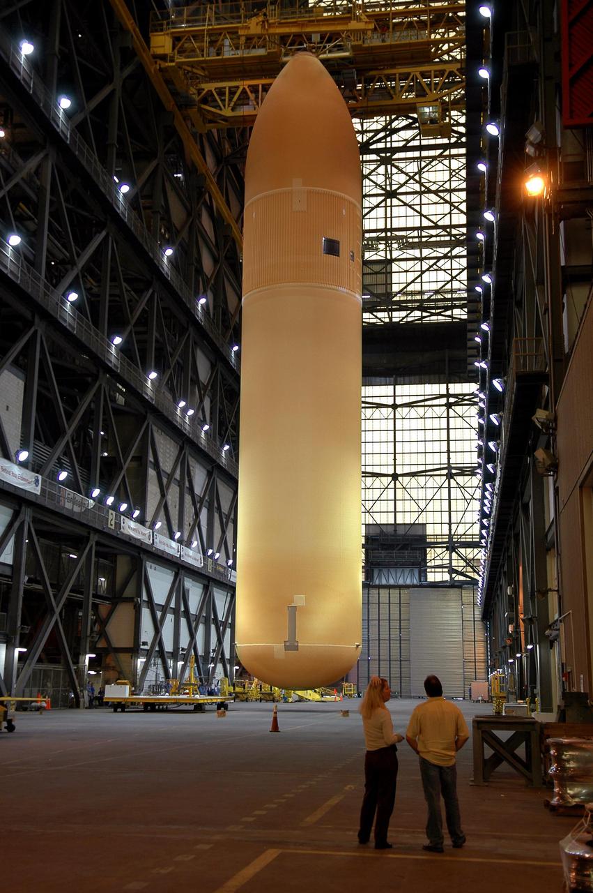 KENNEDY SPACE CENTER, FLA. - In the Vehicle Assembly Building, the redesigned External Tank is being lifted into the 'checkout cell' where the tank’s mechanical, electrical and thermal protection systems are inspected.   The tank will also undergo new processes resulting from its redesign, including inspection of the bipod heater and External Tank separation camera. The tank will be prepared for 'mating' to the Shuttle’s Solid Rocket Boosters. When preparations are complete, the tank will be lifted from the checkout cell, moved across the transfer aisle and into High Bay 1. It will be lowered and attached to the boosters, which are sitting on the Mobile Launch Platform.  The SRBs and ET will be flying with Shuttle Discovery for the Return to Flight mission STS-114.  The launch planning window is May 12 to June 3, 2005.