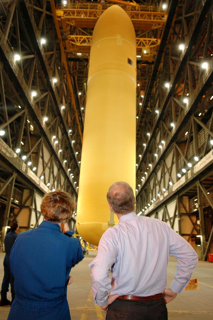 KENNEDY SPACE CENTER, FLA. - Mission STS-114 Commander Eileen Collins and Sen. Bill Nelson watch as the newly redesigned External Tank is lifted in the Vehicle Assembly Building to a “checkout cell” where the tank’s mechanical, electrical and thermal protection systems are inspected. The mission crew and Nelson are at Kennedy to observe tank activities.  The tank will also undergo new processes resulting from its redesign, including inspection of the bipod heater and External Tank separation camera. The tank is designated to fly with Shuttle Discovery on Return to Flight mission STS-114.  The launch window is May 12 to June 3, 2005.