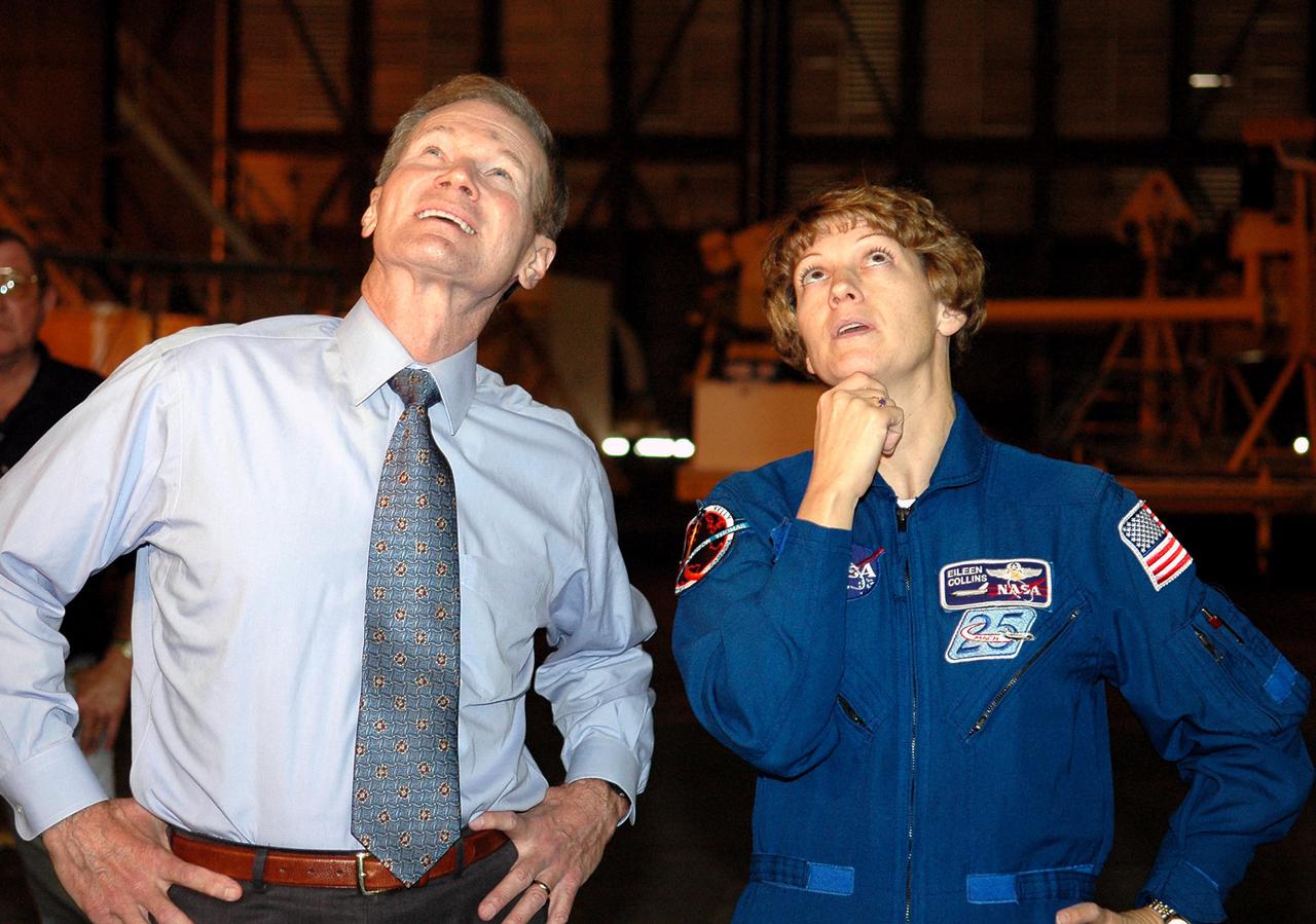 KENNEDY SPACE CENTER, FLA. - Sen. Bill Nelson and STS-114 Mission Commander Eileen Collins watch the newly redesigned External Tank being lifted in the Vehicle Assembly Building to a “checkout cell” where the tank’s mechanical, electrical and thermal protection systems are inspected.  Crew members are at Kennedy to observe tank activities. The tank will also undergo new processes resulting from its redesign, including inspection of the bipod heater and External Tank separation camera.  The tank is designated to fly on Shuttle Discovery on Return to Flight mission STS-114.  The launch window is May 12 to June 3, 2005.