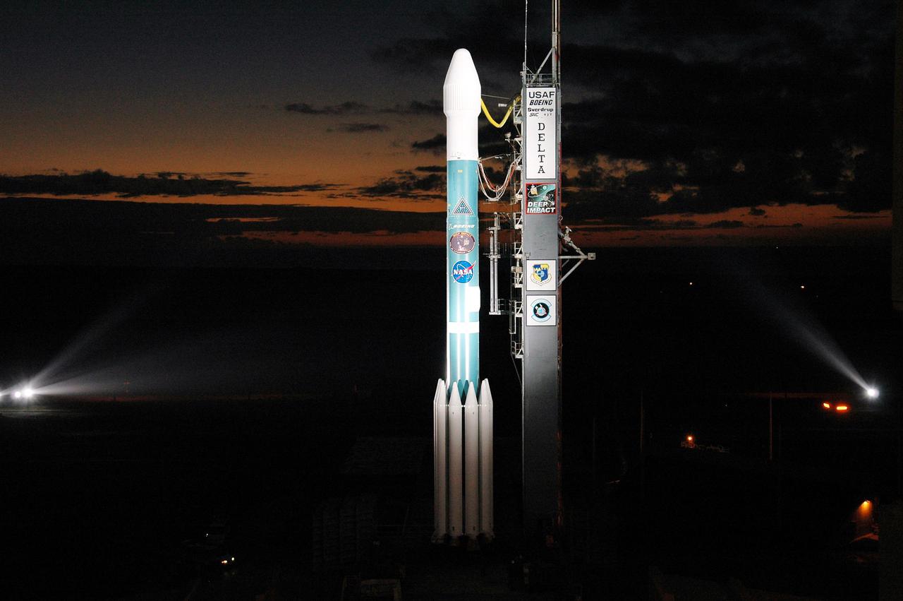 KENNEDY SPACE CENTER, FLA.  -  On Launch Pad 17-B, Cape Canaveral Air Force Station, Fla., the Boeing Delta II carrying the Deep Impact spacecraft rocket shines under spotlights in the early dawn hours as it waits for launch.  Scheduled for liftoff at 1:47 p.m. EST today, Deep Impact will head for space and a rendezvous with Comet Tempel 1 when the comet is 83 million miles from Earth.  After releasing a 3- by 3-foot projectile (impactor) to crash onto the surface July 4, 2005, Deep Impact’s flyby spacecraft will reveal the secrets of the comet’s interior by collecting pictures and data of how the crater forms, measuring the crater’s depth and diameter as well as the composition of the interior of the crater and any material thrown out, and determining the changes in natural outgassing produced by the impact.  It will send the data back to Earth through the antennas of the Deep Space Network.  Deep Impact is a NASA Discovery mission.