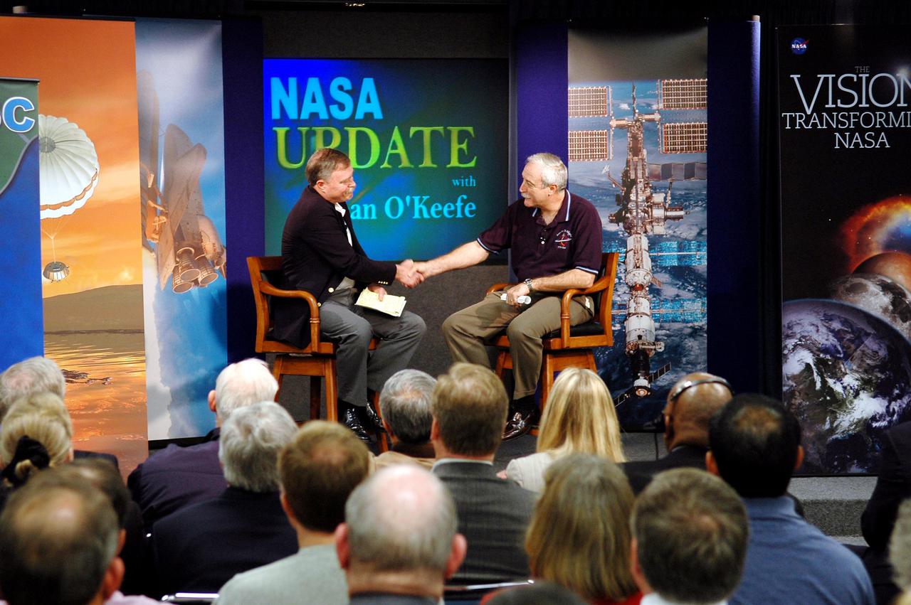KENNEDY SPACE CENTER, FLA. - NASA Administrator Sean O’Keefe (right) is accompanied on stage in the Press Site Auditorium by Associate Administrator of NASA’s Office of Exploration Systems Craig Steidle for a report to employees on the state of the Agency. The update was broadcast live via NASA Television. O'Keefe focused on the achievements of 2004 and the goals set for 2005. His remarks emphasized the milestones met in NASA's Vision for Space Exploration, including the launch of the comet-chasing Deep Impact mission and the landing of the Huygens probe on Jupiter’s moon Titan, both occurring in the past two days, and the progress made in meeting the requirements to return the Space Shuttle to flight. O’Keefe’s briefing included a dialogue with Associate Administrator of NASA’s Office of Exploration Systems Craig Steidle and Center Director Jim Kennedy, live; and Manager of the Space Station Office Bill Gerstenmaier and Director of Advanced Planning and Jet Propulsion Laboratory Charles Elachi, via satellite.