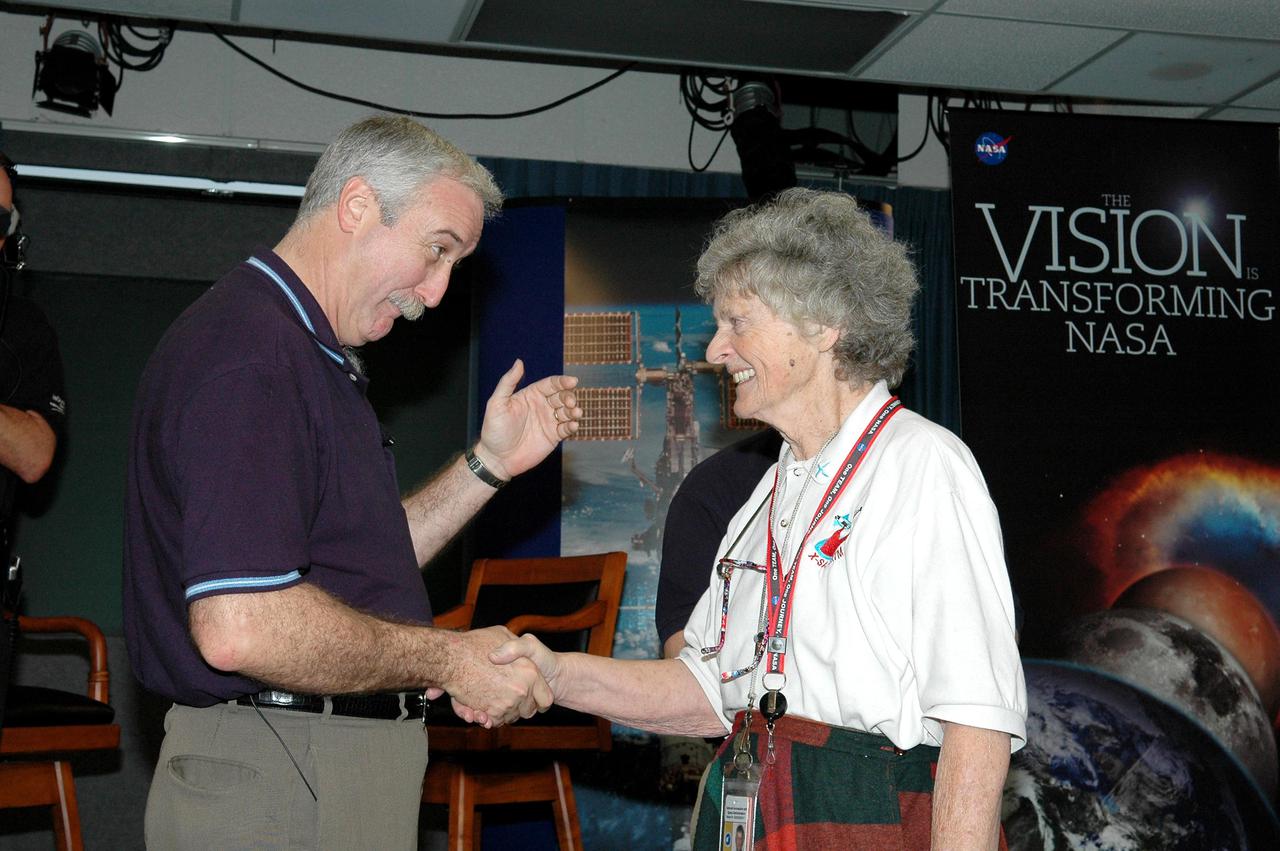 KENNEDY SPACE CENTER, FLA.  -  NASA Administrator Sean O'Keefe (left) congratulates Virginia Whitehead upon her receipt of a One NASA Peer Award. The award recognizes Whitehead for her outstanding customer service. Whitehead is a manager in the Center’s Payload Processing Directorate. The award was presented in the Press Site Auditorium following the administrator's NASA Update. The award is given to recognize employees who have demonstrated behaviors consistent with the spirit of One NASA and are called Peer Awards because candidates must be nominated by their peers.