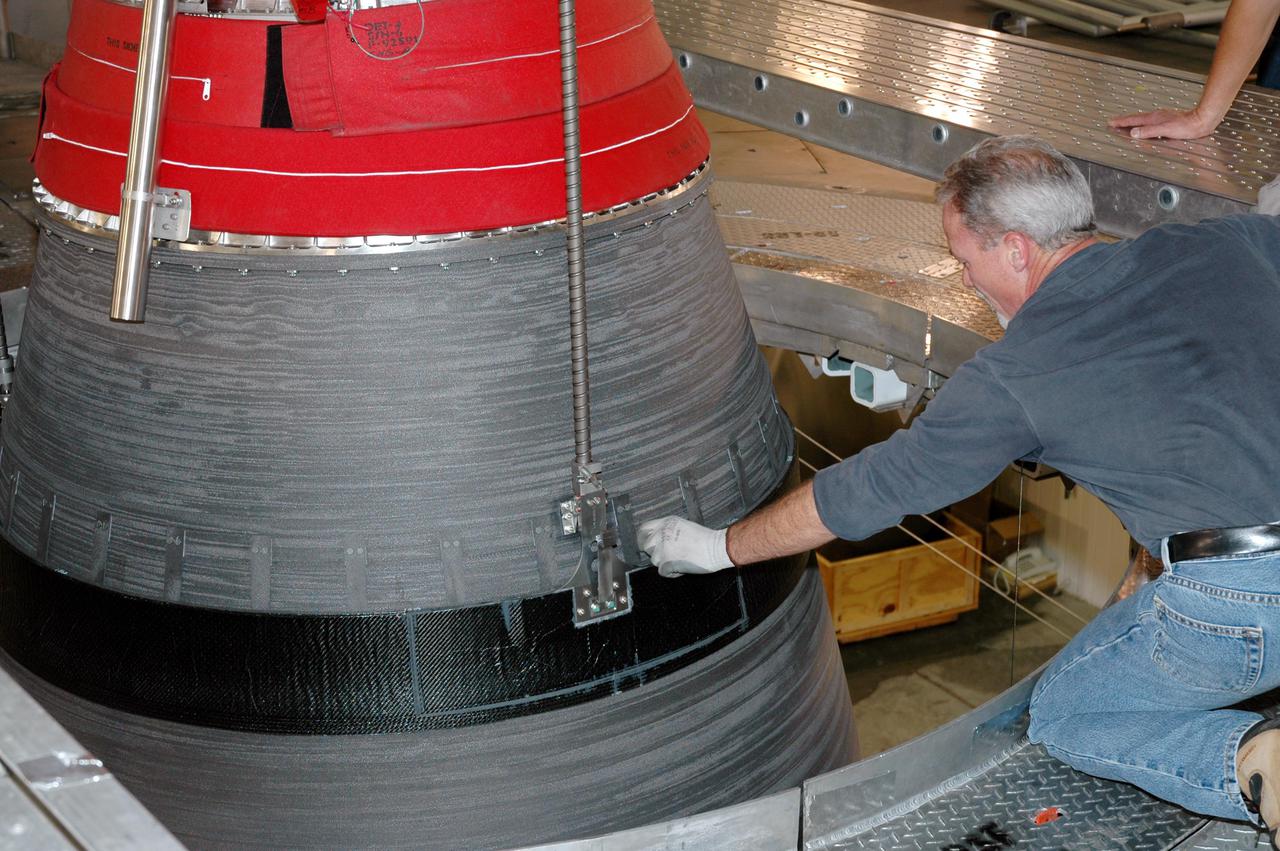 KENNEDY SPACE CENTER, FLA. - At the Delta Operations Center on Cape Canaveral Air Force Station, Fla., a technician closely checks the spacing as the Boeing Delta IV second stage nozzle extension is moved into place for testing. The Delta IV is the launch vehicle for the GOES-N satellite. The Delta IV is the launch vehicle for GOES-N satellite. Geostationary Operational Environmental Satellites (GOES) are sponsored by the National Aeronautics and Space Administration (NASA) and the National Oceanic and Atmospheric Administration (NOAA). GOES-N is the first in the next series of GOES satellites, N-P. The multi-mission GOES series N-P will be a vital contributor to weather, solar and space operations and science. The GOES N-P series will aid activities ranging from severe storm warnings to resource management and advances in science. GOES-N is scheduled to launch May 4 from Cape Canaveral Air Force Station, Fla.