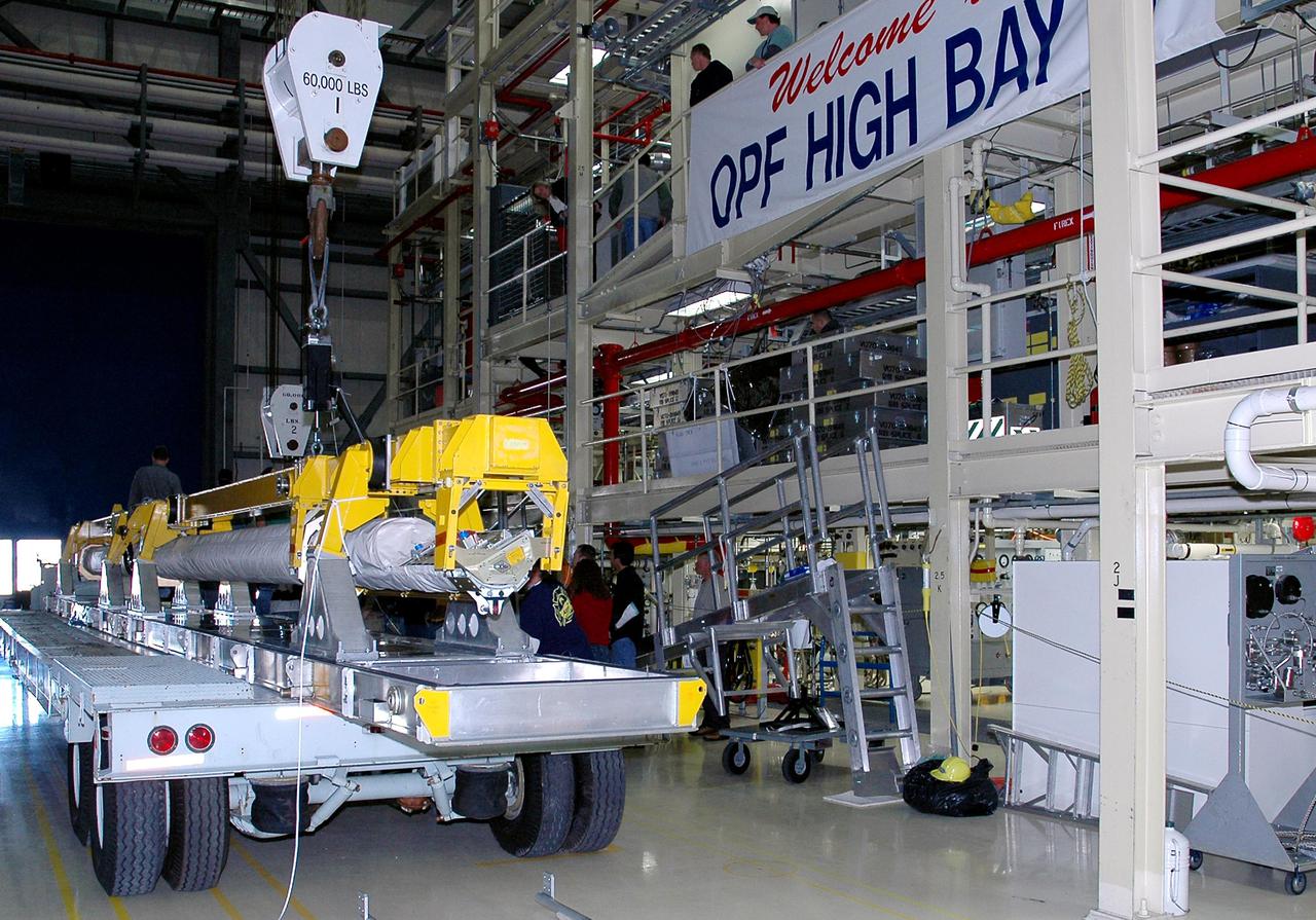 KENNEDY SPACE CENTER, FLA.  - In the Orbiter Processing Facility high bay, the Orbiter Boom Sensor System (OBSS) is fitted with a crane.  After being lifted from its transporter, the OBSS will be installed on the starboard side of the payload bay in the orbiter Discovery.  The 50-foot-long OBSS attaches to the Remote Manipulator System, or Shuttle robotic arm, and is one of the new safety measures for Return to Flight, equipping the orbiter with cameras and laser systems to inspect the Shuttle’s Thermal Protection System while in space.  The Return to Flight mission, STS-114,  has a launch window of May 12 to June 3, 2005.