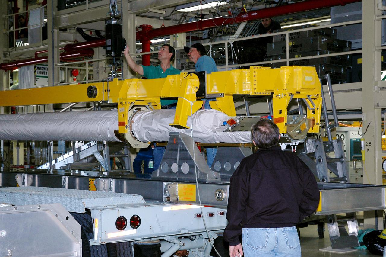 KENNEDY SPACE CENTER, FLA.  - In the Orbiter Processing Facility high bay, technicians check the crane that will lift the Orbiter Boom Sensor System (OBSS)  from its transporter.  The OBSS will be installed on the starboard side of the payload bay in the orbiter Discovery.  The 50-foot-long OBSS attaches to the Remote Manipulator System, or Shuttle robotic arm, and is one of the new safety measures for Return to Flight, equipping the orbiter with cameras and laser systems to inspect the Shuttle’s Thermal Protection System while in space.  The Return to Flight mission, STS-114,  has a launch window of May 12 to June 3, 2005.