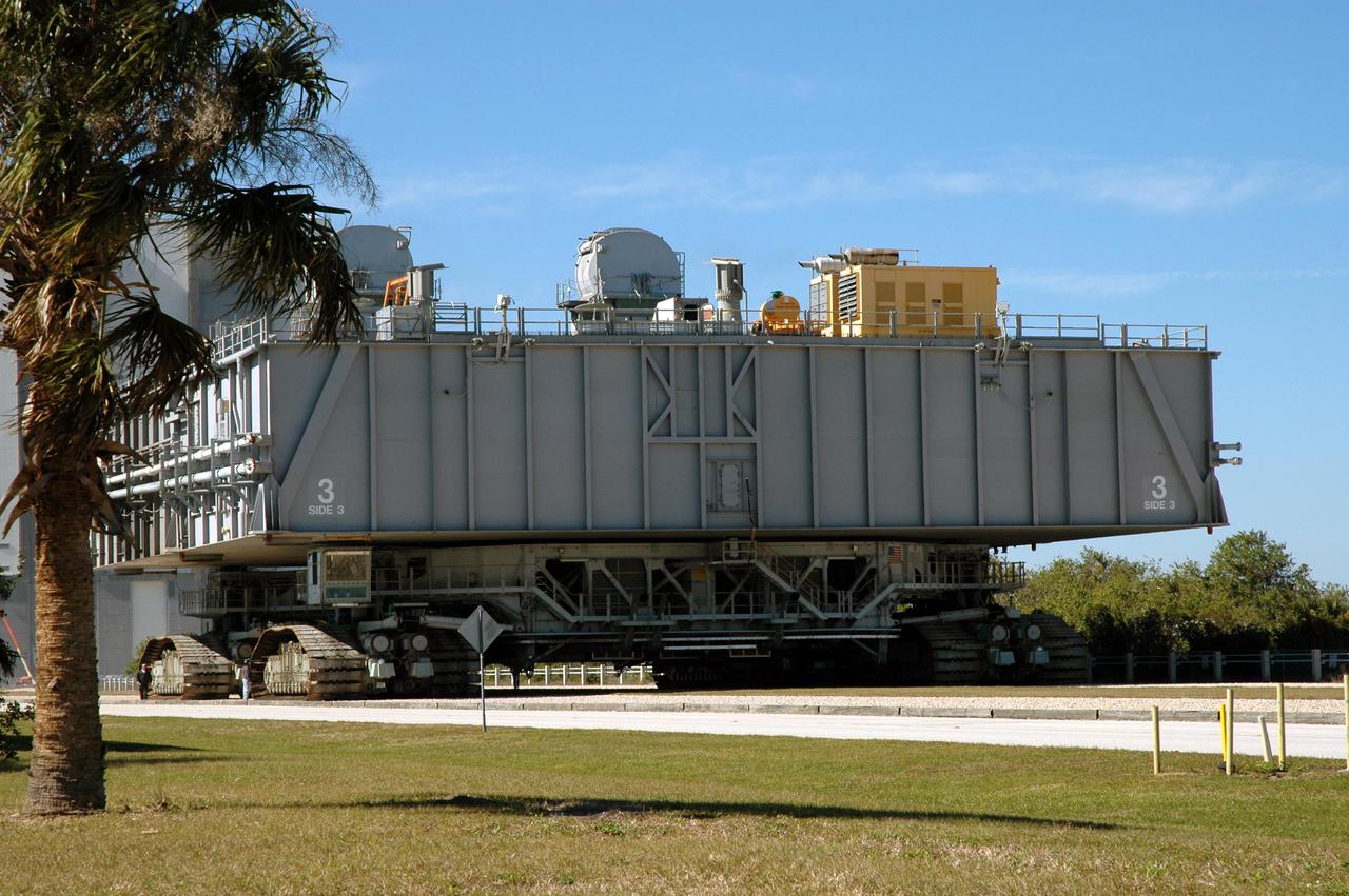 KENNEDY SPACE CENTER, FLA. - The Crawler Transporter that will move Space Shuttle Discovery to the launch pad for Return to Flight demonstrates its readiness for weight bearing by carrying an unloaded 8,230,000-pound Mobile Launch Platform along the crawlerway. Its first road test on Jan. 21, following the replacement of all its shoes, was a success. Cracks appeared in the crawlers' shoes in recent years, spurring a need for replacement. The new manufacturer, in Duluth, Minn., has improved the design for a safe Return to Flight and use through the balance of the Space Shuttle Program. Each crawler has 456 shoes, 57 per belt (8 belts in all). Each shoe weighs 2,200 pounds.