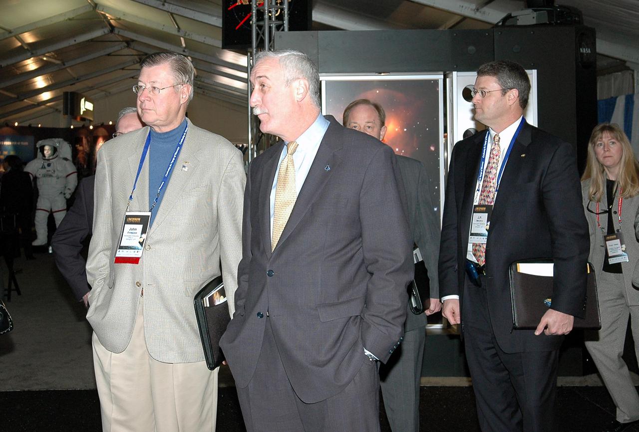 KENNEDY SPACE CENTER, FLA.  - NASA Administrator Sean O’Keefe (center) talks to John Douglass, with the Aerospace Industries Association, at the “1st Space Exploration Conference: Continuing the Voyage of Discovery,” being held at Disney’s Contemporary Resort in Orlando.  O’Keefe is the keynote speaker kicking off the conference.  Douglass is one of the panelists.  Topics being presented focus on new missions, technologies and infrastructure needed to turn the vision for space exploration into reality.  Other keynote speakers at the three-day  conference are Congressman Dave Weldon, film director James Cameron and NASA’s senior Mars scientist James Garvin.  The conference has drawn attendees from around the world.