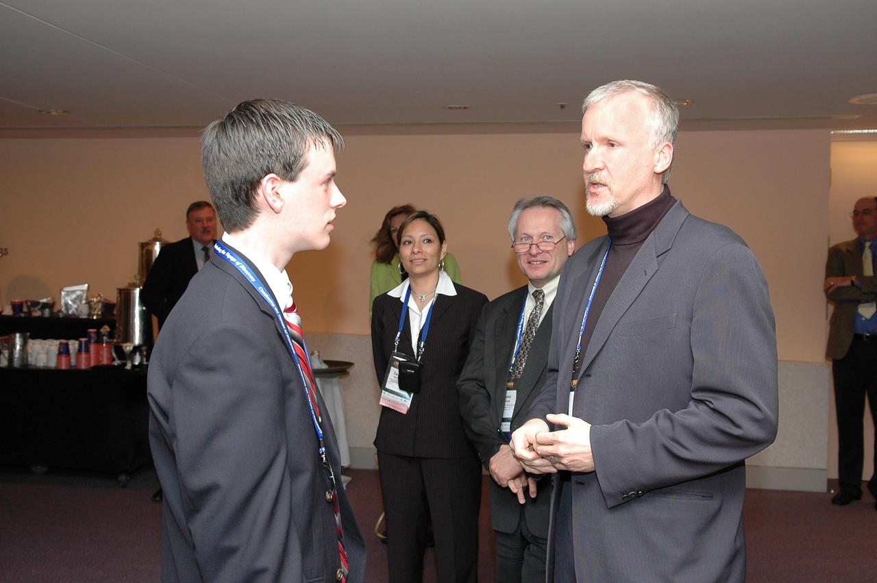 KENNEDY SPACE CENTER, FLA.  - At the “1st Space Exploration Conference: Continuing the Voyage of Discovery,”  held at Disney’s Contemporary Resort in Orlando, film director James Cameron (right) talks to Daniel Stearns, a 13-year-old student from Longmeadow, Mass., who won the Space Exploration Video Festival award sponsored by Lockheed Martin.  Stearns shared first place with a team from McNair High School in Dekalb County, Ga.  The Georgia school participates in NASA’s Explorer School program.  Cameron is one of the keynote speakers at the conference.  Topics being presented focus on new missions, technologies and infrastructure needed to turn the vision for space exploration into reality.  Other keynote speakers at the three-day  conference are Congressman Dave Weldon, film director James Cameron and NASA’s senior Mars scientist James Garvin.  The conference has drawn attendees from around the world.