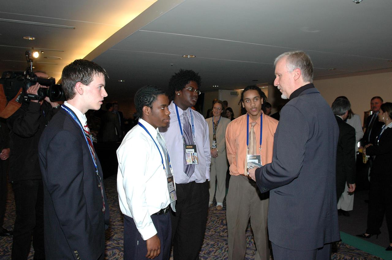 KENNEDY SPACE CENTER, FLA.  - At the “1st Space Exploration Conference: Continuing the Voyage of Discovery,”  held at Disney’s Contemporary Resort in Orlando, film director James Cameron (right) talks to the winning students of the Space Exploration Video Festival award sponsored by Lockheed Martin.  At left is Daniel Stearns, from East Longmeadow, Mass.  The others are Daniel Jackson, Trenten Nash and Theo Maxie, from the NASA Explorer School McNair High School in Dekalb County, Ga..  Cameron is one of the keynote speakers at the conference.  Topics being presented focus on new missions, technologies and infrastructure needed to turn the vision for space exploration into reality. Keynote speakers at the three-day conference include NASA Administrator Sean O'Keefe, Congressman Dave Weldon, film director James Cameron and NASA’s senior Mars scientist James Garvin.  The conference has drawn attendees from around the world.