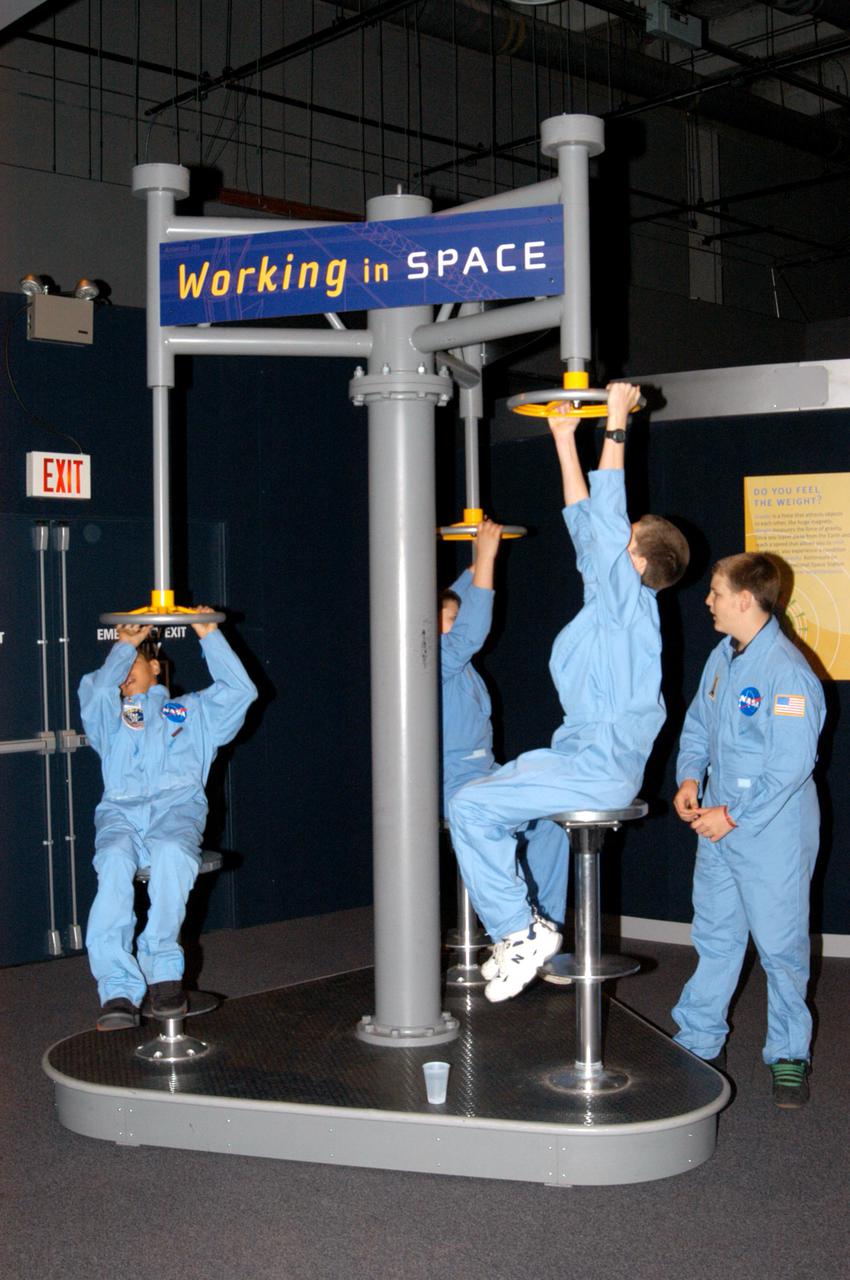 KENNEDY SPACE CENTER, FLA. - At the Museum of Science and Industry (MOSI) in Tampa, students from one of NASA’s Explorer Schools, Stewart Middle School in Tampa, enjoy an interactive exhibit. The students are at MOSI to view the space exhibit Space: A Journey to Our Future, an extraordinary, interactive exhibition designed to entertain, educate and inspire. Another exhibit is SPACE STATION, the first cinematic journey to the International Space Station (ISS), where audiences can experience for themselves life in zero gravity aboard the new station.