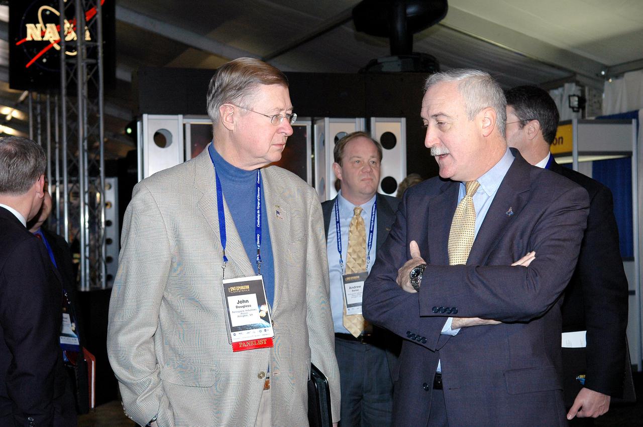 KENNEDY SPACE CENTER, FLA.  - NASA Administrator Sean O’Keefe (center) talks to John Douglass, with the Aerospace Industries Association, at the “1st Space Exploration Conference: Continuing the Voyage of Discovery,” being held at Disney’s Contemporary Resort in Orlando.  O’Keefe is the keynote speaker kicking off the conference.  Douglass is one of the panelists.  Topics being presented focus on new missions, technologies and infrastructure needed to turn the vision for space exploration into reality. Other keynote speakers at the three-day conference include Congressman Dave Weldon, film director James Cameron and NASA’s senior Mars scientist James Garvin.  The conference has drawn attendees from around the world.