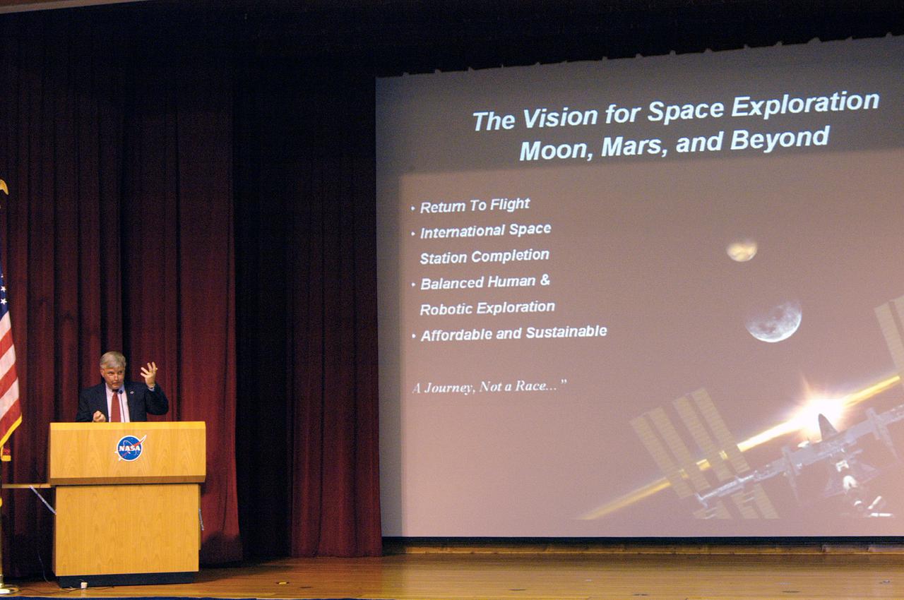 KENNEDY SPACE CENTER, FLA.  - At an All Hands Meeting, Center Director Jim Kennedy talks to employees in the Training Auditorium about the Vision for Space Exploration and the Center’s role.  He also talked about the NASA budget and its implications for the Center.  NASA Administrator Sean O’Keefe presented on Feb. 8 the Administration's fiscal year 2006 budget proposal and its relevance to the Vision for Space Exploration.