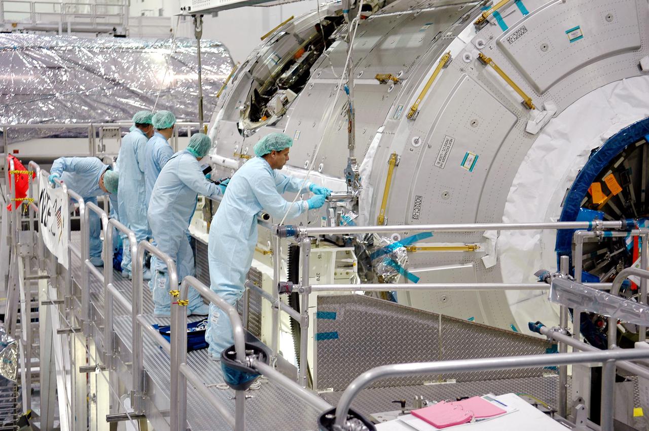 KENNEDY SPACE CENTER, FLA.  - Technicians in the Space Station Processing Facility begin to attach a crane to the International Space Station module Node 2.  The module is being moved from a workstand to a payload canister for transfer to the Operations and Checkout Building.  There it will undergo an element leak test.  The installation of NASA's Node 2 will denote the U.S. Core Complete stage of International Space Station assembly and increase the living and working space inside the station to approximately 18,000 cubic feet. It also will allow the addition of international laboratories from Europe and Japan to the station.  Node 2 will provide a passageway between four station science experiment facilities: the U.S. Destiny Laboratory, the Kibo Japanese Experiment Module, the European Columbus Laboratory and the Centrifuge Accommodation Module. It also will provide connecting ports for Multi-Purpose Logistics Modules, the Japanese H II Transfer Vehicle and the Pressurized Mating Adapter 2 to which Space Shuttles dock. The Space Station Robotic Arm, Canadarm2, can operate from a powered grapple fixture on the exterior of Node 2.  It is scheduled for launch on shuttle mission STS-120, station assembly flight 10A.