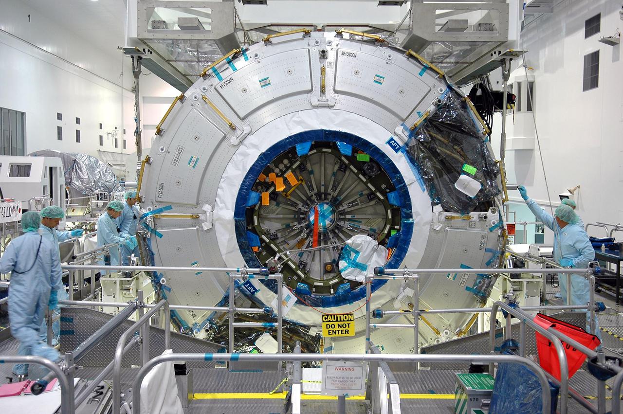 KENNEDY SPACE CENTER, FLA.  - Technicians in the Space Station Processing Facility complete attaching a crane to the International Space Station module Node 2.  The module is being moved from a workstand to a payload canister for transfer to the Operations and Checkout Building.  There it will undergo an element leak test.  The installation of NASA's Node 2 will denote the U.S. Core Complete stage of International Space Station assembly and increase the living and working space inside the station to approximately 18,000 cubic feet. It also will allow the addition of international laboratories from Europe and Japan to the station.  Node 2 will provide a passageway between four station science experiment facilities: the U.S. Destiny Laboratory, the Kibo Japanese Experiment Module, the European Columbus Laboratory and the Centrifuge Accommodation Module. It also will provide connecting ports for Multi-Purpose Logistics Modules, the Japanese H II Transfer Vehicle and the Pressurized Mating Adapter 2 to which Space Shuttles dock. The Space Station Robotic Arm, Canadarm2, can operate from a powered grapple fixture on the exterior of Node 2.  It is scheduled for launch on shuttle mission STS-120, station assembly flight 10A.