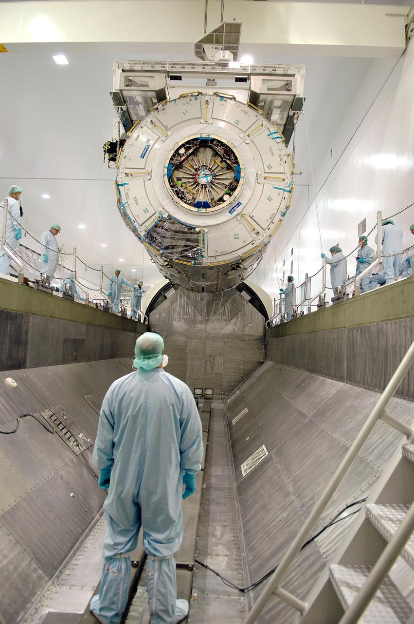 KENNEDY SPACE CENTER, FLA.  - In the Space Station Processing Facility, the International Space Station module Node 2 is lowered toward a payload canister.  The module is being transferred to the Operations and Checkout Building  where it will undergo an element leak test.  The installation of NASA's Node 2 will denote the U.S. Core Complete stage of International Space Station assembly and increase the living and working space inside the station to approximately 18,000 cubic feet. It also will allow the addition of international laboratories from Europe and Japan to the station.  Node 2 will provide a passageway between four station science experiment facilities: the U.S. Destiny Laboratory, the Kibo Japanese Experiment Module, the European Columbus Laboratory and the Centrifuge Accommodation Module. It also will provide connecting ports for Multi-Purpose Logistics Modules, the Japanese H II Transfer Vehicle and the Pressurized Mating Adapter 2 to which Space Shuttles dock. The Space Station Robotic Arm, Canadarm2, can operate from a powered grapple fixture on the exterior of Node 2.  It is scheduled for launch on shuttle mission STS-120, station assembly flight 10A.