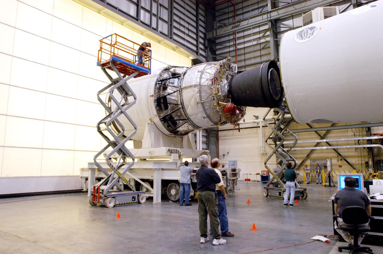 KENNEDY SPACE CENTER, FLA. - In the Horizontal Integration Facility, the GOES-N_Boeing Delta IV second stage (left) is being mated to the first stage. The Boeing Delta IV rocket will be used for the 2005 launching of the GOES-N weather satellite for NASA and NOAA (National Oceanic and Atmospheric Administration). The first in a series of three advanced weather satellites that include GOES-O and GOES-P, the GOES-N will provide continuous monitoring necessary for intensive data analysis. It will provide a constant vigil for the atmospheric “triggers” of severe weather conditions such as tornadoes, flash floods, hail storms and hurricanes. When these conditions develop, GOES-N will be able to monitor storm development and track their movements. Launch of GOES-N is scheduled for May 4 from Cape Canaveral Air Force Station.