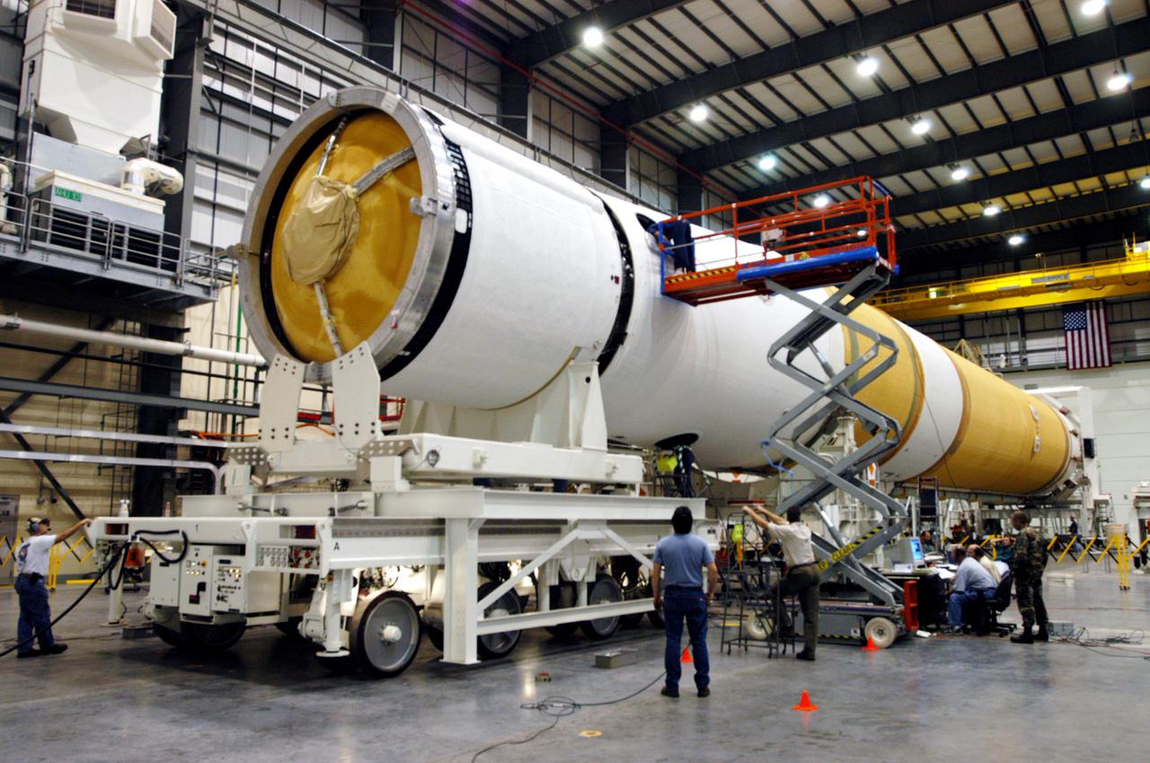 KENNEDY SPACE CENTER, FLA. -In the Horizontal Integration Facility, technicians complete the mating of the GOES-N_Boeing Delta IV second stage (left) to the first stage. The Boeing Delta IV rocket will be used for the 2005 launching of the GOES-N weather satellite for NASA and NOAA (National Oceanic and Atmospheric Administration). The first in a series of three advanced weather satellites that include GOES-O and GOES-P, the GOES-N will provide continuous monitoring necessary for intensive data analysis. It will provide a constant vigil for the atmospheric “triggers” of severe weather conditions such as tornadoes, flash floods, hail storms and hurricanes. When these conditions develop, GOES-N will be able to monitor storm development and track their movements. Launch of GOES-N is scheduled for May 4 from Cape Canaveral Air Force Station.