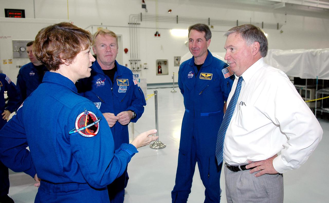 KENNEDY SPACE CENTER, FLA.  - In the Space Station Processing Facility, STS-114 Mission Commander Eileen Collins talks to Tip Talone (right), director of International Space Station Payload Processing.  Other crew members behind them are Pilot James Kelly (left) and Mission Specialists Andrew Thomas (center left) and Stephen Robinson (center right). The crew is at KSC for Crew Equipment Interface Test (CEIT) activities.  During CEIT, the crew has an opportunity to get a hands-on look at the payloads with which they’ll be working on-orbit.  The Return to Flight mission STS-114 will carry the Multi-Purpose Logistics Module Raffaello, filled with supplies for the International Space Station, and a replacement Control Moment Gyroscope.  Launch of STS-114 has a launch window of May 12 to June 3.