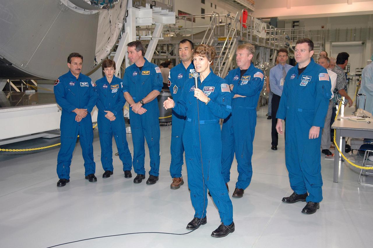 KENNEDY SPACE CENTER, FLA.  - After looking over some of the hardware in the Space Station Processing Facility, STS-114 crew members answer questions from the media.  At the microphone is Commander Eileen Collins.  Behind her are (left to right) Mission Specialists Charles Camarda, Wendy Lawrence, Stephen Robinson, Soichi Noguchi (with the Japanese Space Agency) and Andrew Thomas, and Pilot James Kelly.  The crew is at KSC for Crew Equipment Interface Test (CEIT) activities.  During CEIT, the crew has an opportunity to get a hands-on look at the payloads with which they’ll be working on-orbit.  The Return to Flight mission STS-114 will carry the Multi-Purpose Logistics Module Raffaello, filled with supplies for the International Space Station, and a replacement Control Moment Gyroscope.  Launch of STS-114 has a launch window of May 12 to June 3.