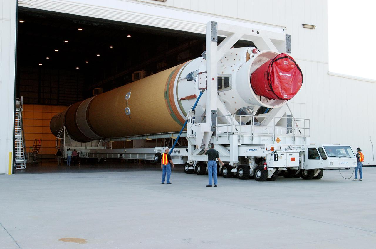 KENNEDY SPACE CENTER, FLA. - The first and second stages of the Boeing Delta IV rocket moves out of the Horizontal Integration Facility, where they were mated, at Cape Canaveral Air Force Station. The rocket is being transferred to the launch pad for further build-up and mating with the GOES-N satellite. Launch of the GOES-N is scheduled for May 4. The satellite is the first of three for the National Oceanic and Atmospheric Administration that will provide continuous monitoring necessary for intensive data analysis. GOES-N will provide a constant vigil for the atmospheric “triggers” of severe weather conditions such as tornadoes, flash floods, hail storms and hurricanes. When these conditions develop, GOES-N will be able to monitor storm development and track their movements. NASA’s Goddard Space Flight Center is responsible for development of the satellite and testing of the spacecraft and its instruments.
