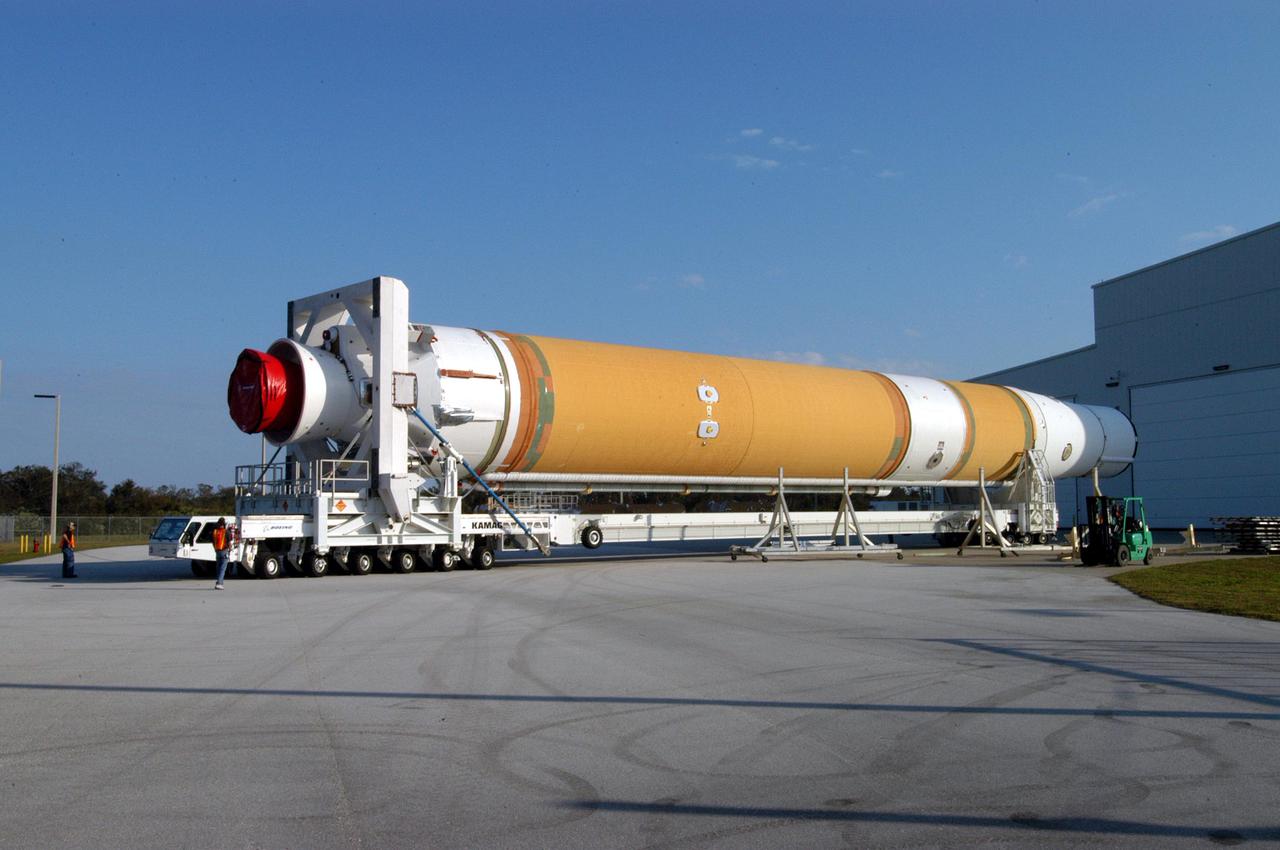 KENNEDY SPACE CENTER, FLA. - The first and second stages of the Boeing Delta IV rocket negotiates a turn from the Horizontal Integration Facility, where the two stages were mated, at Cape Canaveral Air Force Station. The rocket is being transferred to the launch pad for further build-up and mating with the GOES-N satellite. Launch of the GOES-N is scheduled for May 4. The satellite is the first of three for the National Oceanic and Atmospheric Administration that will provide continuous monitoring necessary for intensive data analysis. GOES-N will provide a constant vigil for the atmospheric “triggers” of severe weather conditions such as tornadoes, flash floods, hail storms and hurricanes. When these conditions develop, GOES-N will be able to monitor storm development and track their movements. NASA’s Goddard Space Flight Center is responsible for development of the satellite and testing of the spacecraft and its instruments.