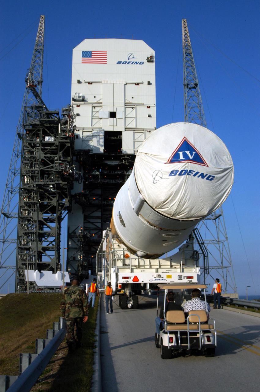 KENNEDY SPACE CENTER, FLA. - The first and second stages of the Boeing Delta IV rocket arrive at Launch Pad 37-B at Cape Canaveral Air Force Station after leaving the Horizontal Integration Facility, where the two stages were mated. The Delta IV is scheduled to launch the GOES-N satellite May 4. The satellite is the first of three for the National Oceanic and Atmospheric Administration that will provide continuous monitoring necessary for intensive data analysis. GOES-N will provide a constant vigil for the atmospheric “triggers” of severe weather conditions such as tornadoes, flash floods, hail storms and hurricanes. When these conditions develop, GOES-N will be able to monitor storm development and track their movements. NASA’s Goddard Space Flight Center is responsible for development of the satellite and testing of the spacecraft and its instruments.