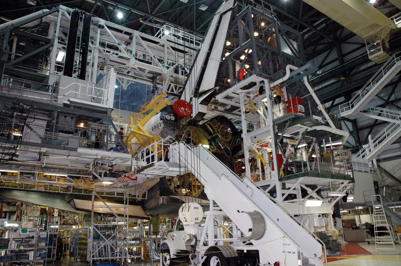 KENNEDY SPACE CENTER, FLA. - In Orbiter Process Facility bay 1, the installation of the left Orbital Maneuvering System (OMS) pod on Space Shuttle Atlantis is complete. The Orbital Maneuvering System provides the thrust for orbit insertion, orbit circularization, orbit transfer, rendezvous, deorbit, abort to orbit and abort once around. It can provide up to 1,000 pounds of propellant to the aft reaction control system. Each pod contains one OMS engine and the hardware needed to pressurize, store and distribute the propellants to perform the velocity maneuvers. Atlantis is the designated orbiter to fly on mission STS-121. The mission has a launch window of July 12 - July 31.