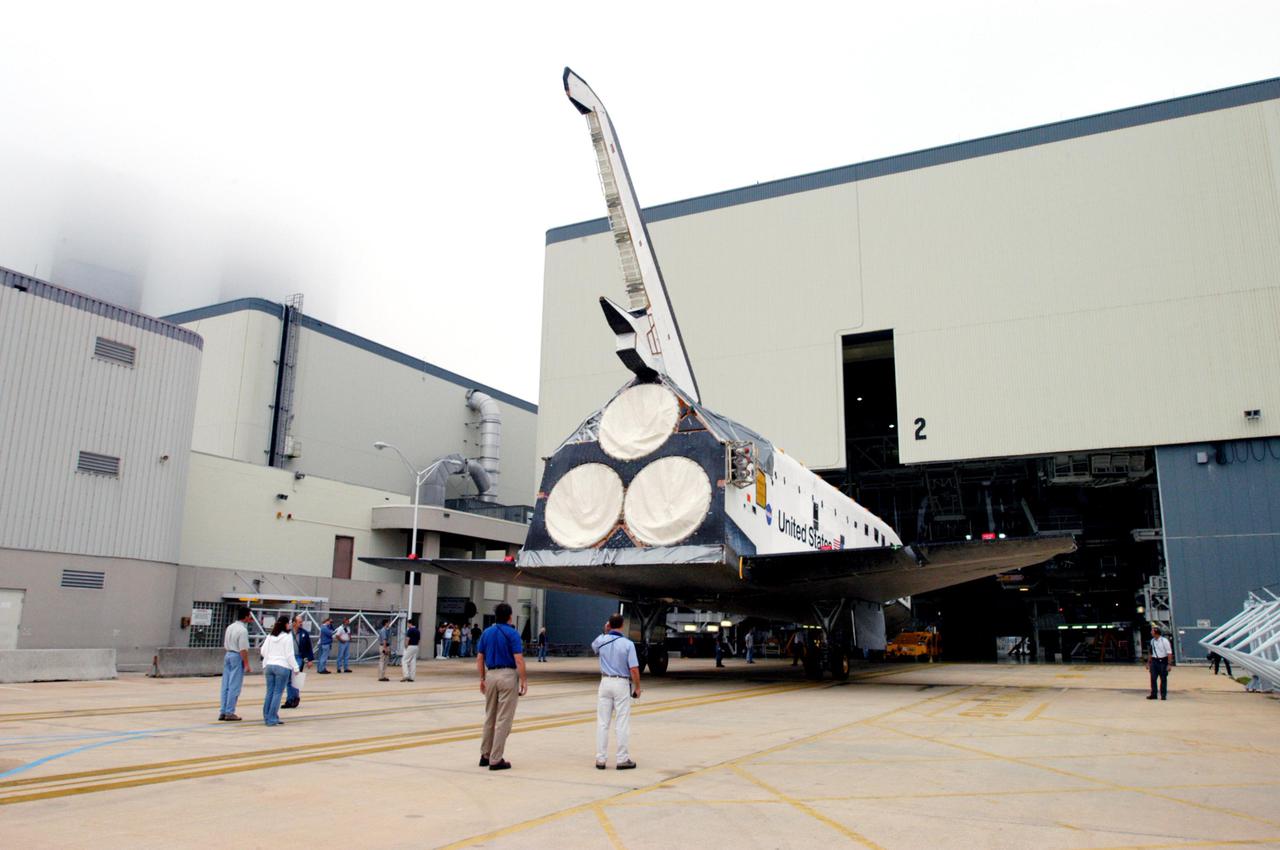 KENNEDY SPACE CENTER, FLA.  - The orbiter Endeavour rolls out of the Orbiter Processing Facility.  It is being moved to Florida Space Authority’s Reusable Launch Vehicle hangar for temporary storage.  It left the Orbiter Processing Facility (OPF) to allow work to be performed in the OPF that can only be accomplished while the bay is empty.  Work scheduled in the OPF includes modifications to the bay and platform validation in the bay.   Endeavour will remain in the hangar for approximately 30 days, then return to the OPF.  Endeavour was pulled out of service in December 2003 for Orbiter Major Modification (OMM).  OMMs are scheduled at regular intervals to enhance safety and performance, infuse new technology, and, in this case, perform RTF modifications.