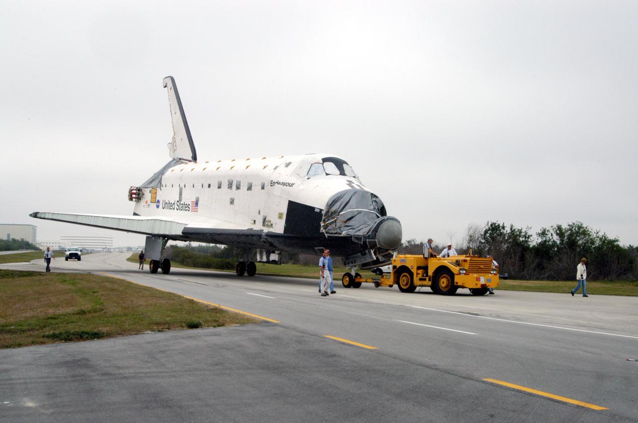 KENNEDY SPACE CENTER, FLA.  - - The orbiter Endeavour is being towed to Florida Space Authority’s Reusable Launch Vehicle hangar for temporary storage.  Endeavour is being moved from the Orbiter Processing Facility (OPF) to allow work to be performed in the OPF that can only be accomplished while the bay is empty.  Work scheduled in the OPF includes modifications to the bay and platform validation in the bay.   Endeavour will remain in the hangar for approximately 30 days, then return to the OPF.  Endeavour was pulled out of service in December 2003 for Orbiter Major Modification (OMM).  OMMs are scheduled at regular intervals to enhance safety and performance, infuse new technology, and, in this case, perform RTF modifications.