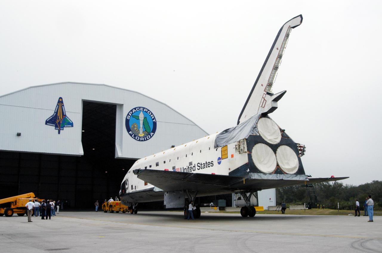 KENNEDY SPACE CENTER, FLA.  - The orbiter Endeavour is towed into Florida Space Authority’s Reusable Launch Vehicle hangar for temporary storage.  Endeavour is being moved from the Orbiter Processing Facility (OPF) to allow work to be performed in the OPF that can only be accomplished while the bay is empty.   Work scheduled in the OPF includes modifications to the bay and platform validation in the bay.   Endeavour will remain in the hangar for approximately 30 days, then return to the OPF.  Endeavour was pulled out of service in December 2003 for Orbiter Major Modification (OMM).  OMMs are scheduled at regular intervals to enhance safety and performance, infuse new technology, and, in this case, perform RTF modifications.