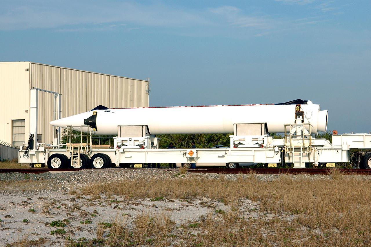KENNEDY SPACE CENTER, FLA.  - A Solid Rocket Booster destined for the GOES-N launch is moved away from the Receipt Inspection Storage building.  It is being transported to Launch Complex 37 at Cape Canaveral Air Force Station for attachment to the Boeing Delta IV rocket.  The Delta IV is the launch vehicle for the GOES-N satellite, the first of three for the National Oceanic and Atmospheric Administration that will provide continuous monitoring necessary for intensive data analysis. GOES-N will provide a constant vigil for the atmospheric “triggers” of severe weather conditions such as tornadoes, flash floods, hail storms and hurricanes. When these conditions develop, GOES-N will be able to monitor storm development and track their movements.  NASA’s Goddard Space Flight Center is responsible for development of the satellite and testing of the spacecraft and its instruments.  GOES-N is scheduled for launch on May 4.