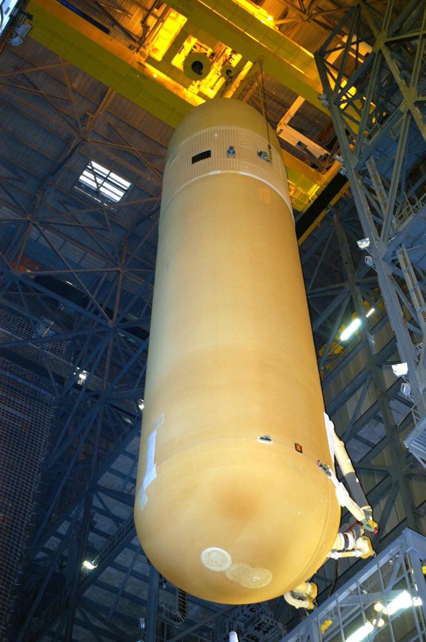 KENNEDY SPACE CENTER, FLA.  -  The External Tank (ET) designated to fly on Return to Flight mission STS-114 is lifted above the checkout cell to be mated with the Solid Rocket Boosters.  The ET is recently redesigned  to meet recommendations of the Columbia Accident Investigation Board before return to flight.  Among dozens of changes is a redesigned forward bipod fitting to reduce the risk to the Space Shuttle from falling debris during ascent.  Considered a test flight, STS-114 is scheduled to launch during a window extending May 15 to June 3.  The Shuttle will carry supplies and equipment to the International Space Station.