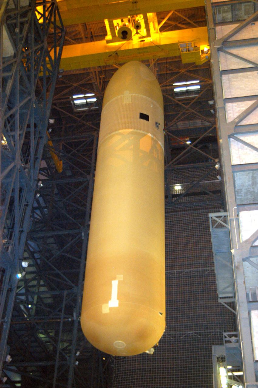 KENNEDY SPACE CENTER, FLA.  -  In the Vehicle Assembly Building, the External Tank (ET) designated to fly on Return to Flight mission STS-114 is moved to the Solid Rocket Boosters for mating.  The ET is recently redesigned  to meet recommendations of the Columbia Accident Investigation Board before return to flight.  Among dozens of changes is a redesigned forward bipod fitting to reduce the risk to the Space Shuttle from falling debris during ascent.  Considered a test flight, STS-114 is scheduled to launch during a window extending May 15 to June 3.  The Shuttle will carry supplies and equipment to the International Space Station.